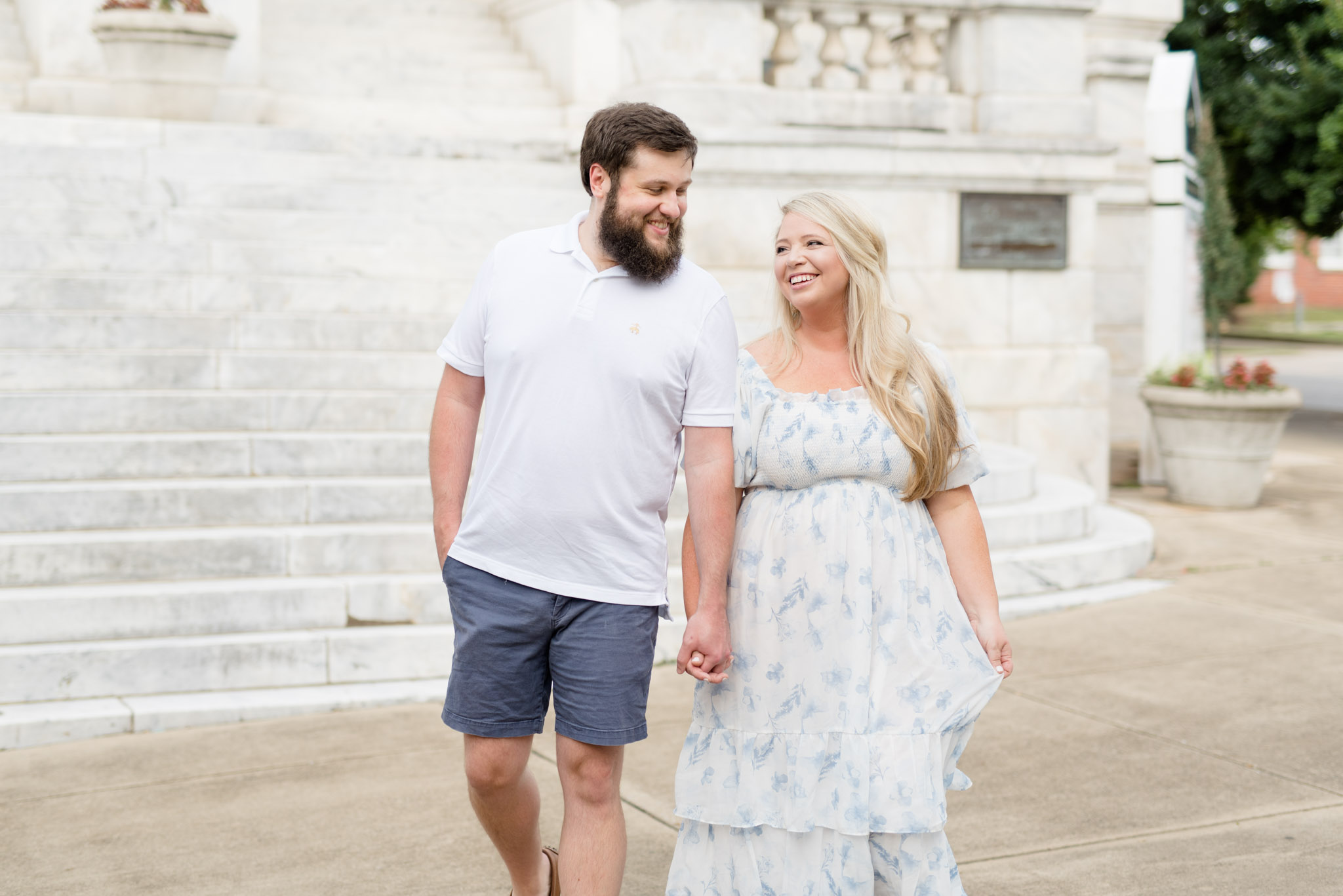Husband and wife laugh as they walk.