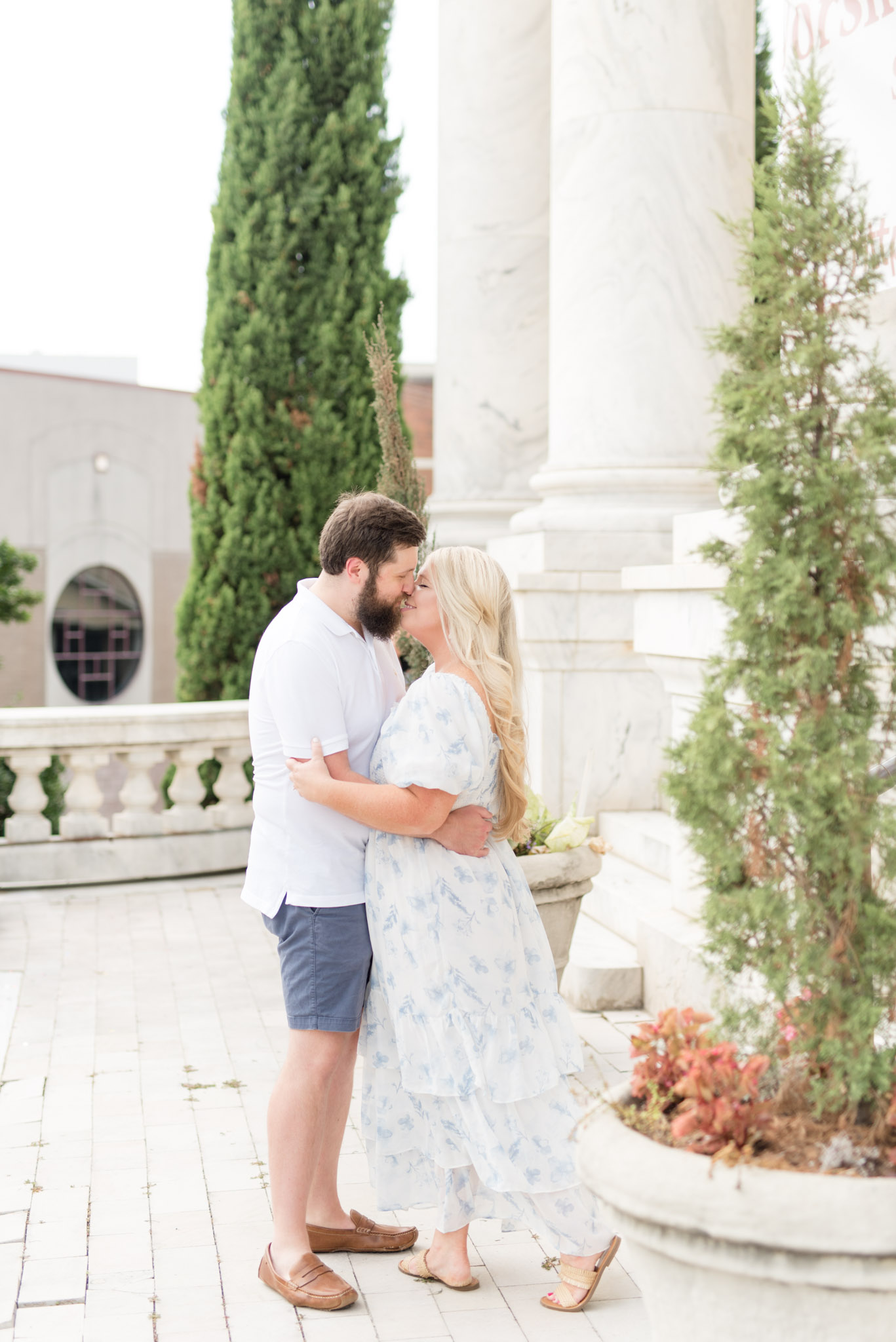 Married couple smile and lean in for kiss.