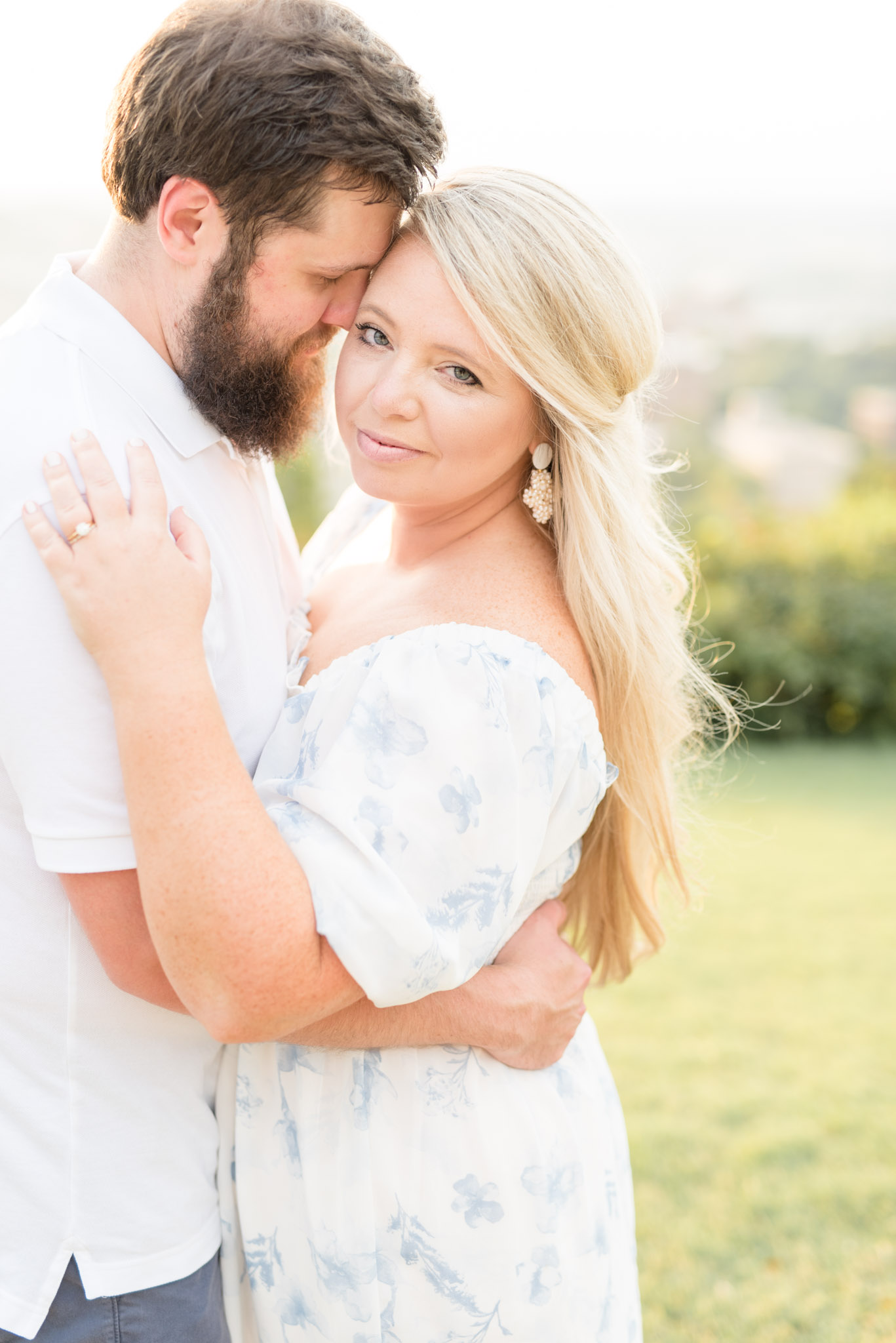 Woman looks at camera while husband snuggles.