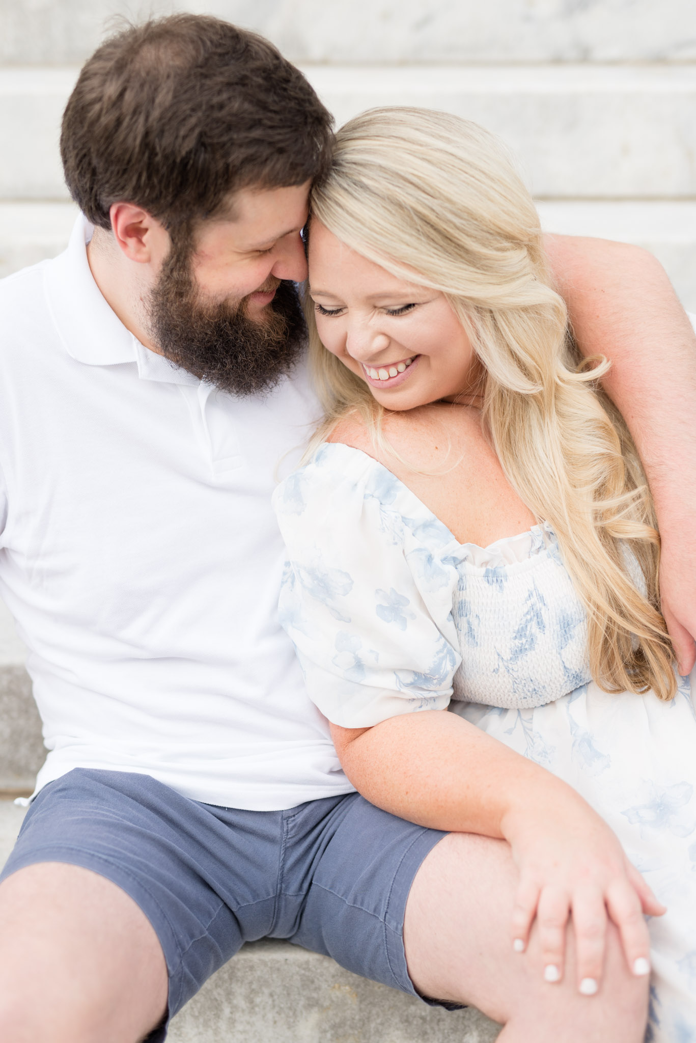 Married couple cuddle and laugh.