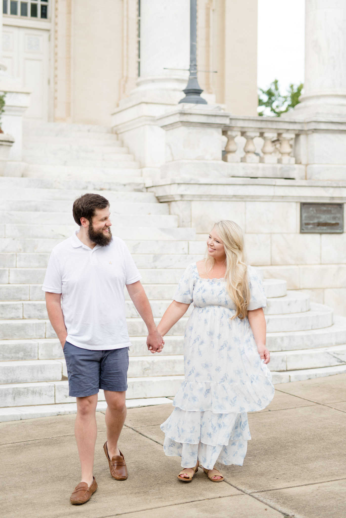 Married couple walk and laugh together.