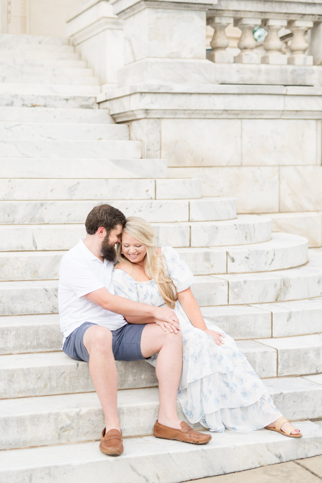 Husband and wife sit together and smile.