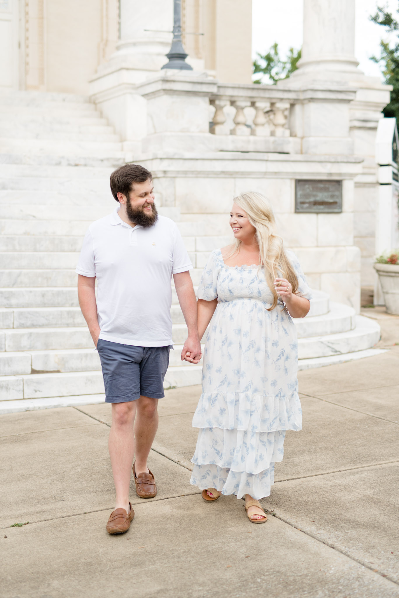 Married couple walk and laugh together.