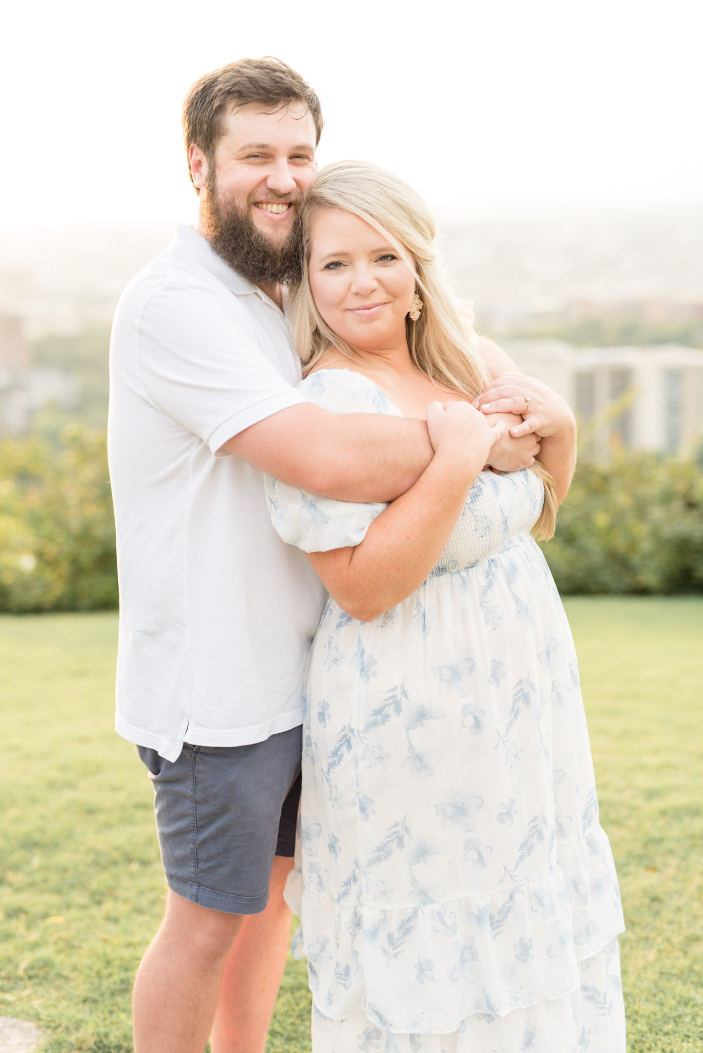 Married couple hug and smile.