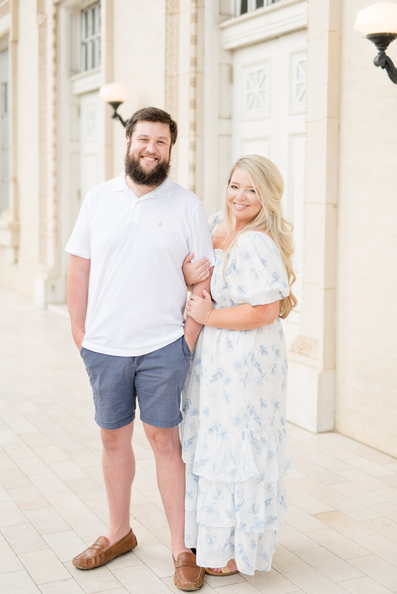 Husband and wife smile at camera.