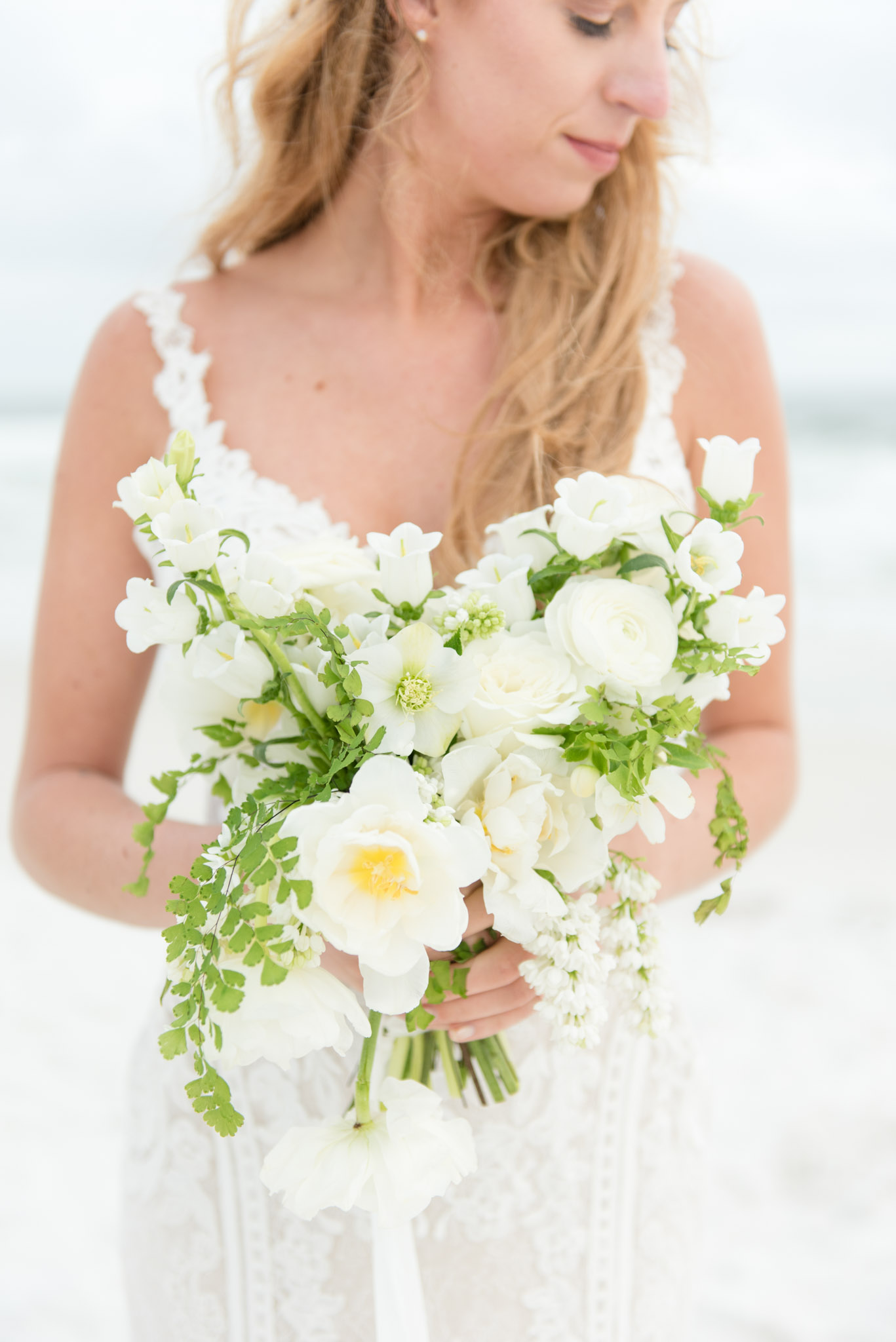 Bride holds wedding bouquet.