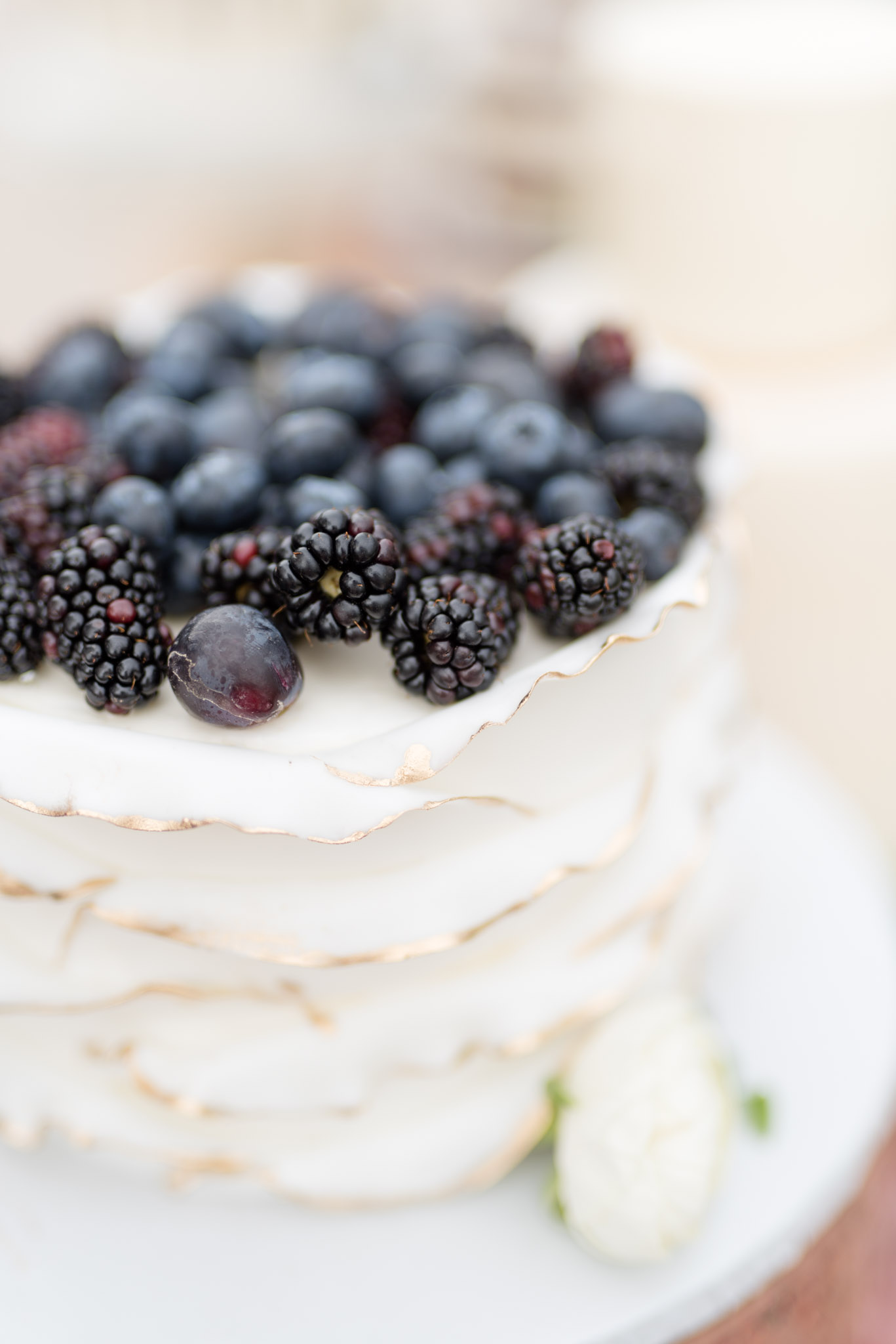 Wedding cake with berries on top.
