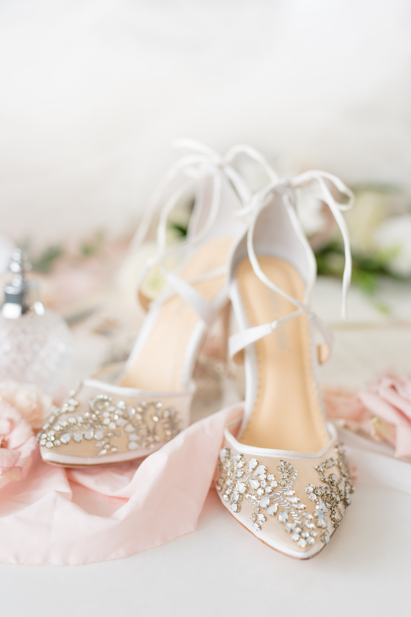 Jeweled wedding shoes sit with blush details.