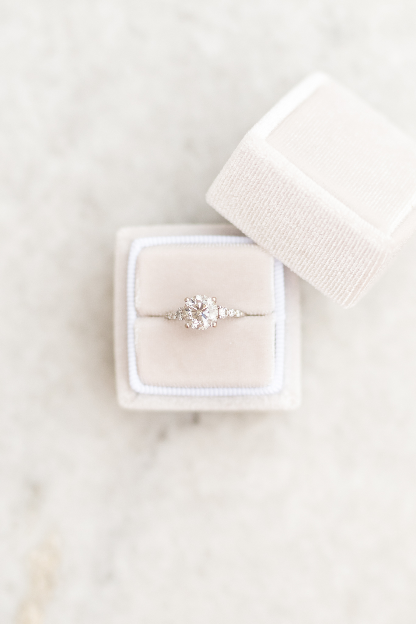 Engagement ring sits in velvet ring box.