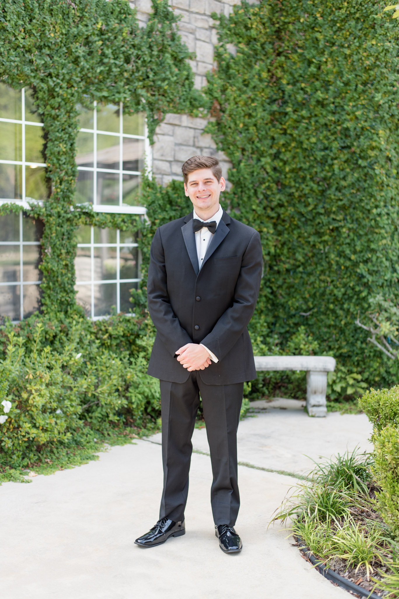 Groom smiles at the camera.