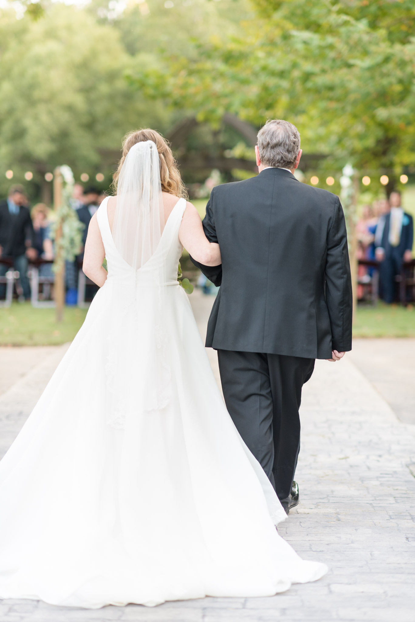 Bride and father walking down aisle.