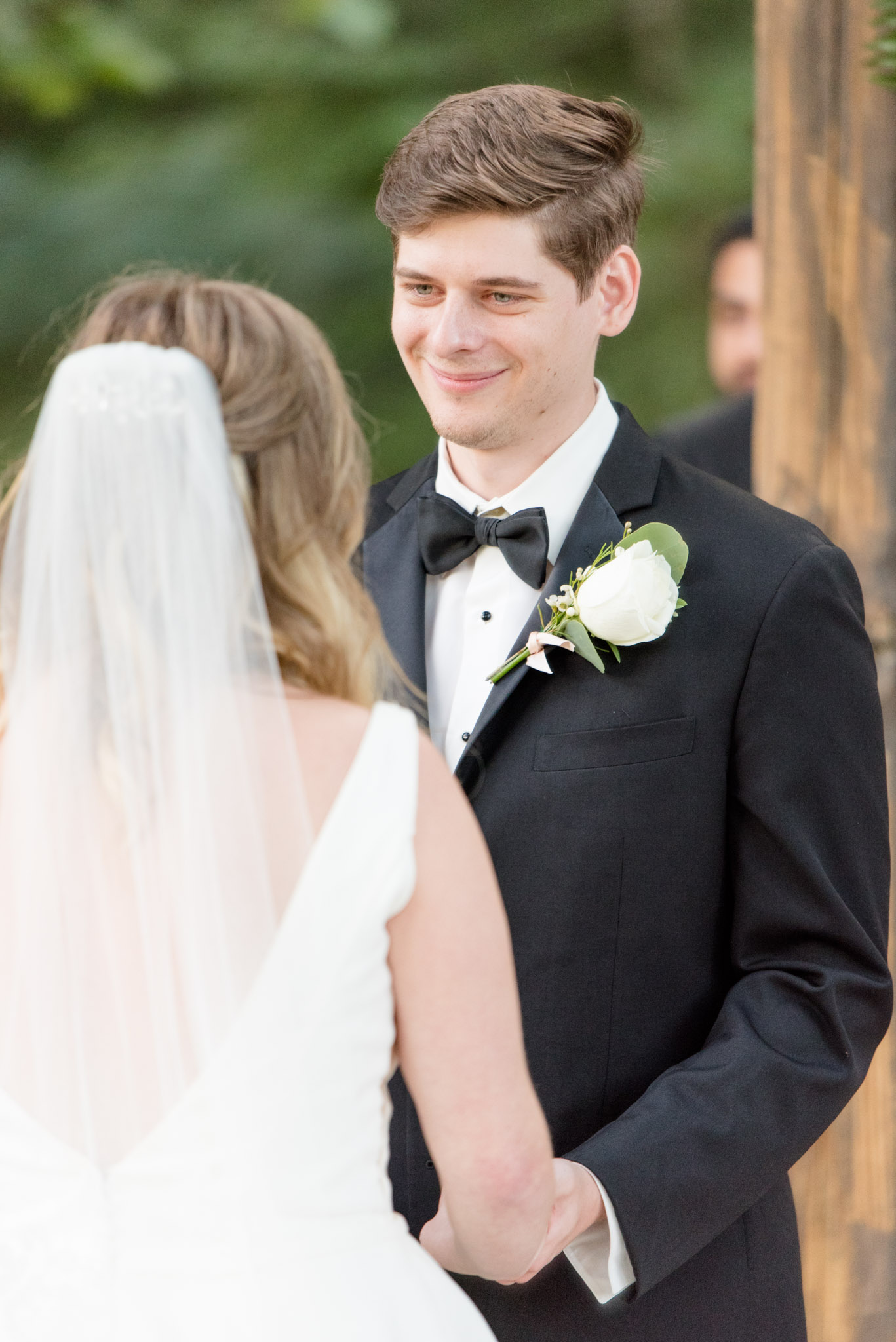 groom looks at bride during ceremony.
