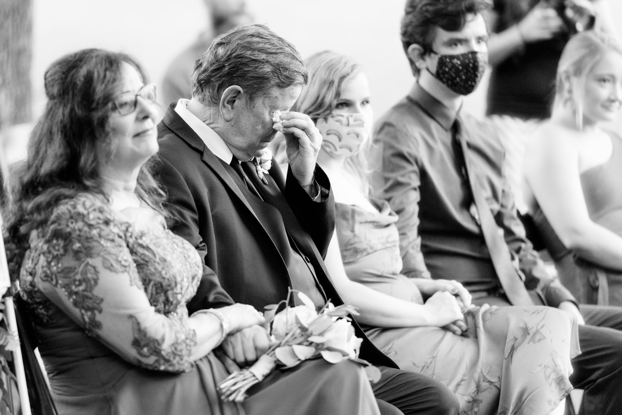 Father of the bride cries during wedding ceremony.