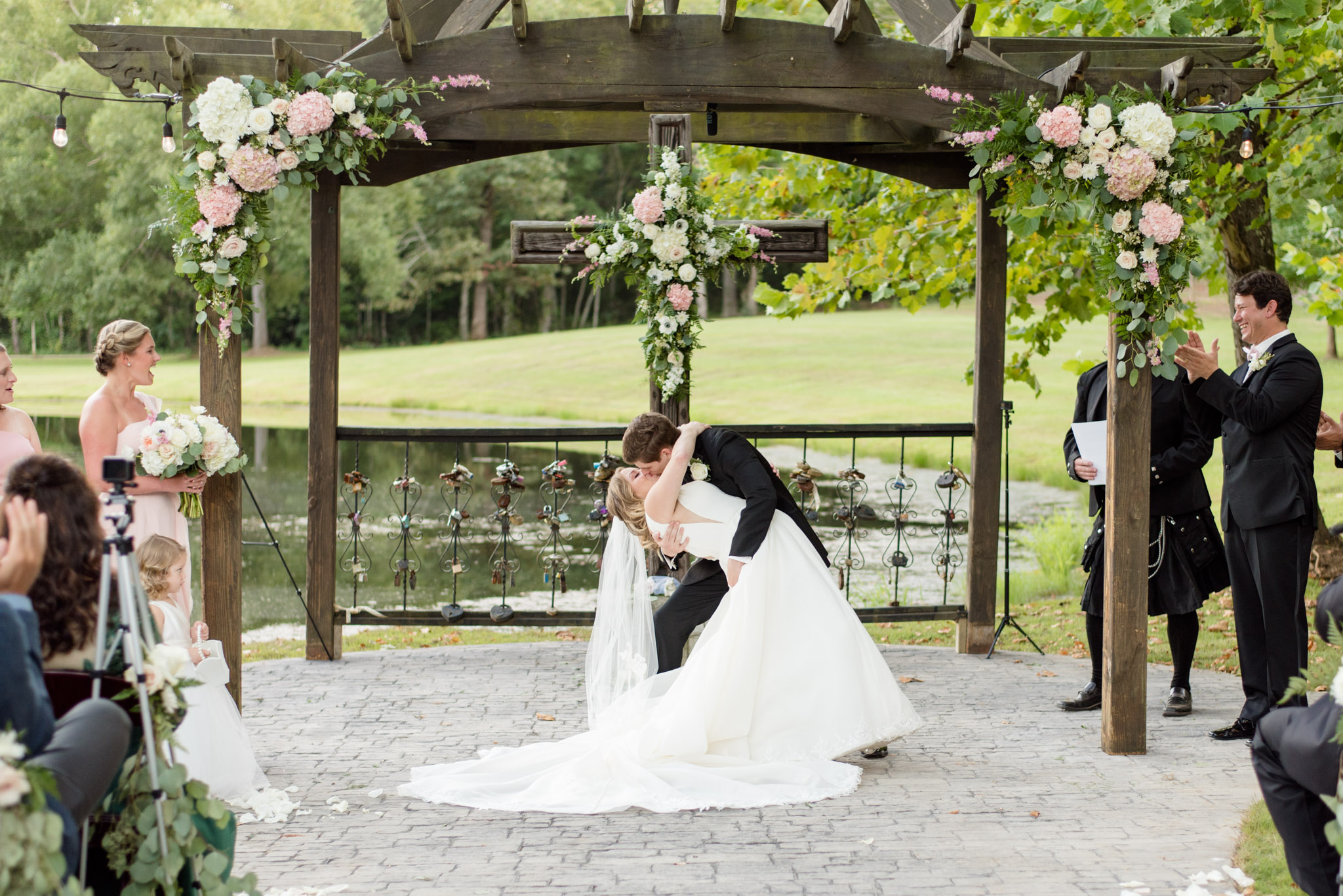 Groom dips bride for first kiss.