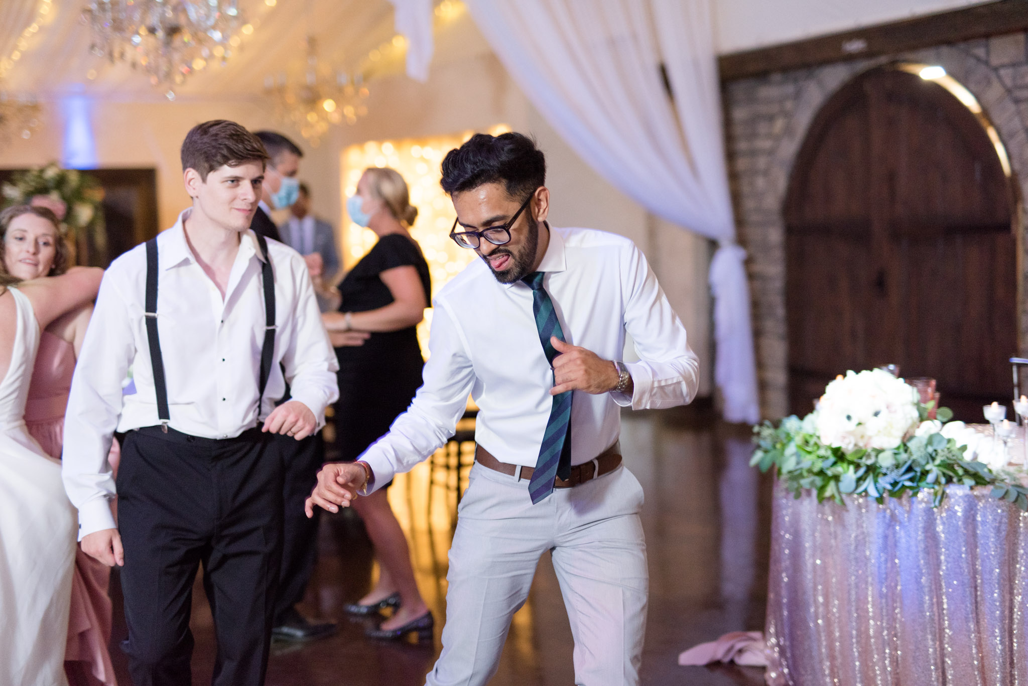 Wedding guests dance.