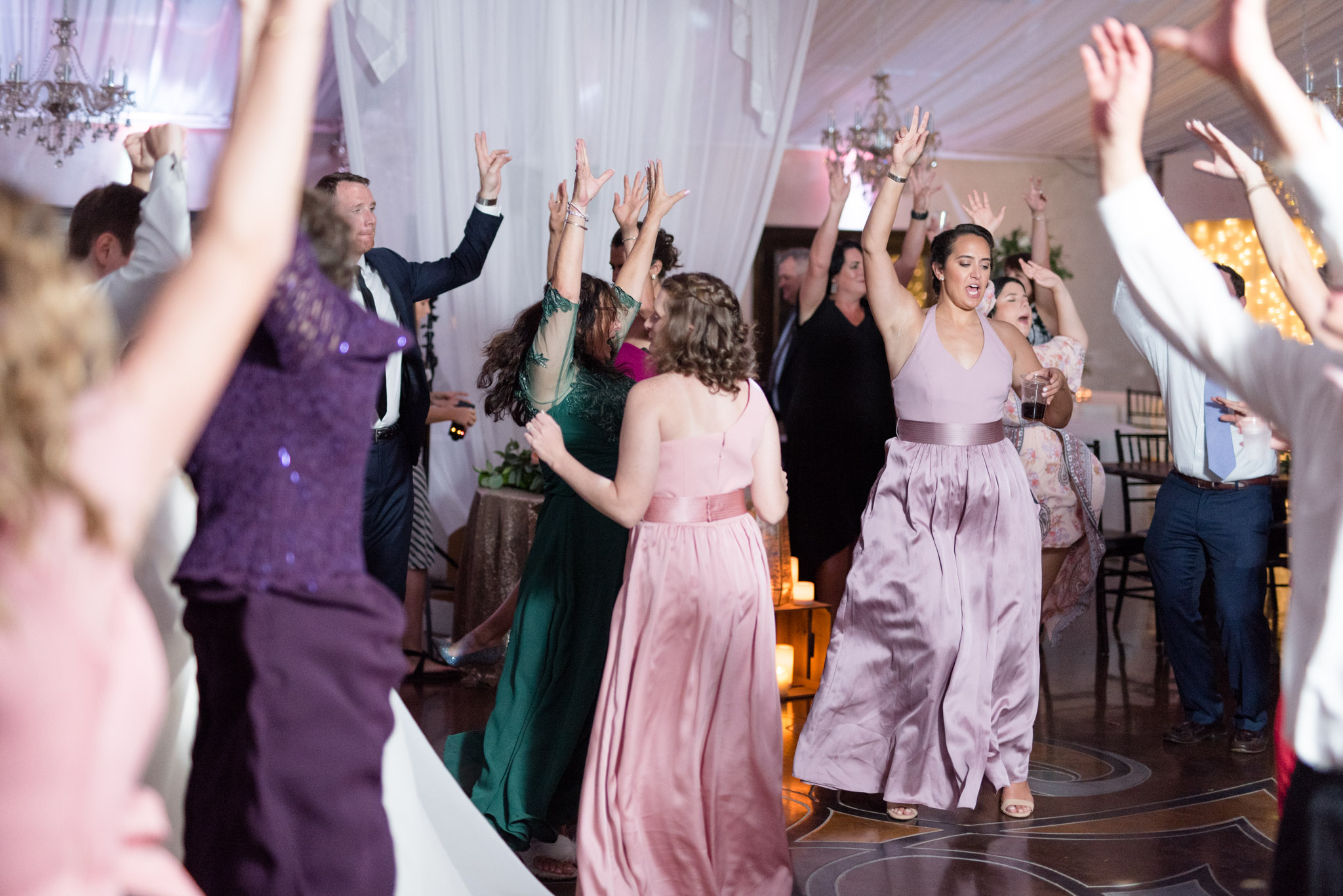 Wedding guests jump during dancing.