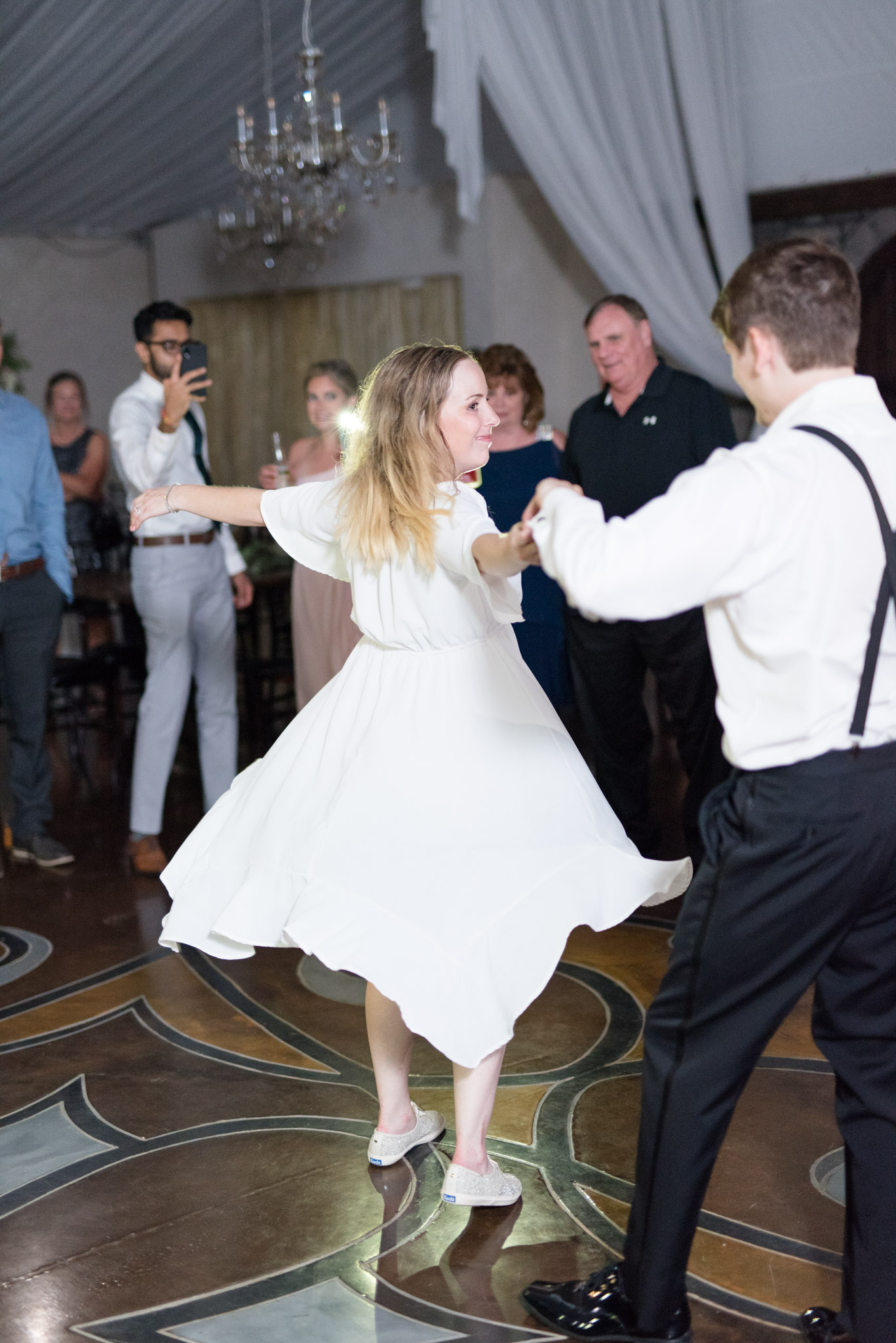 Bride twirls on dance floor.