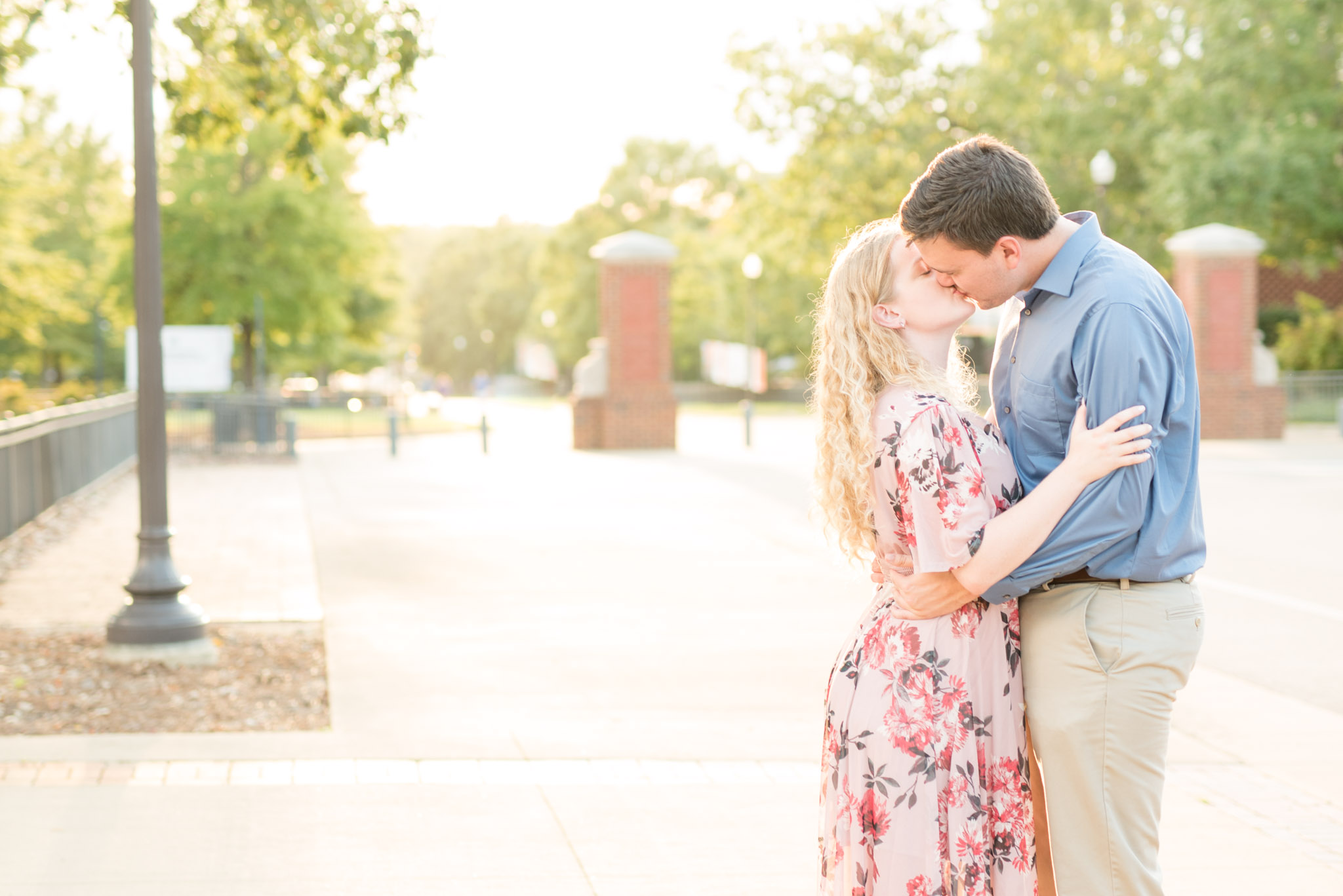 Couple kisses at Auburn University at sunset.