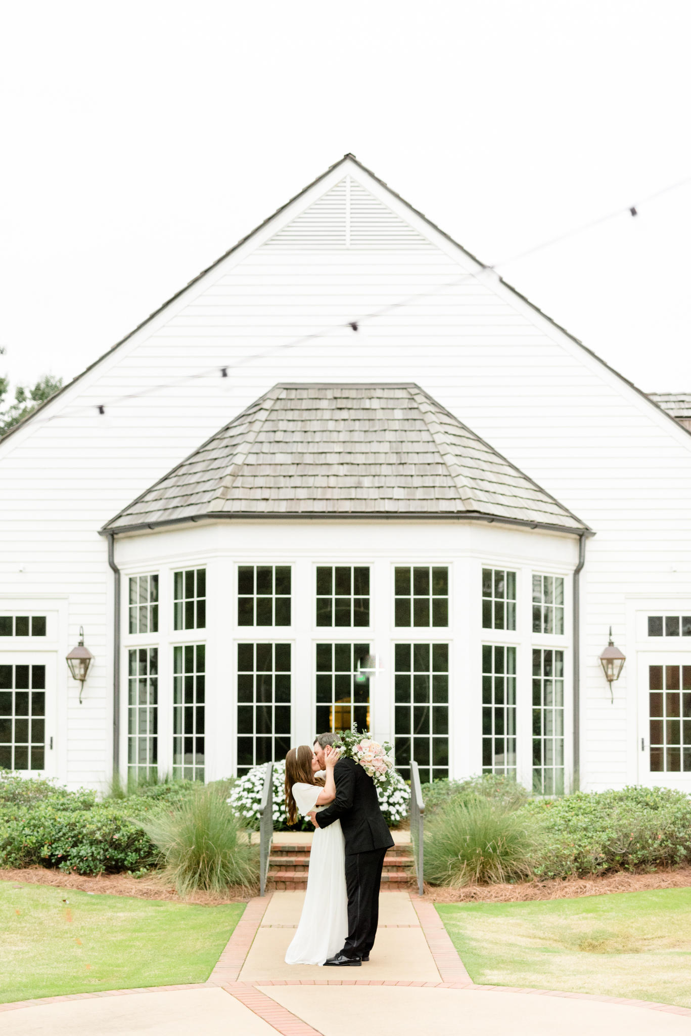 Couple kisses at Hamilton Place at Pursell Farms