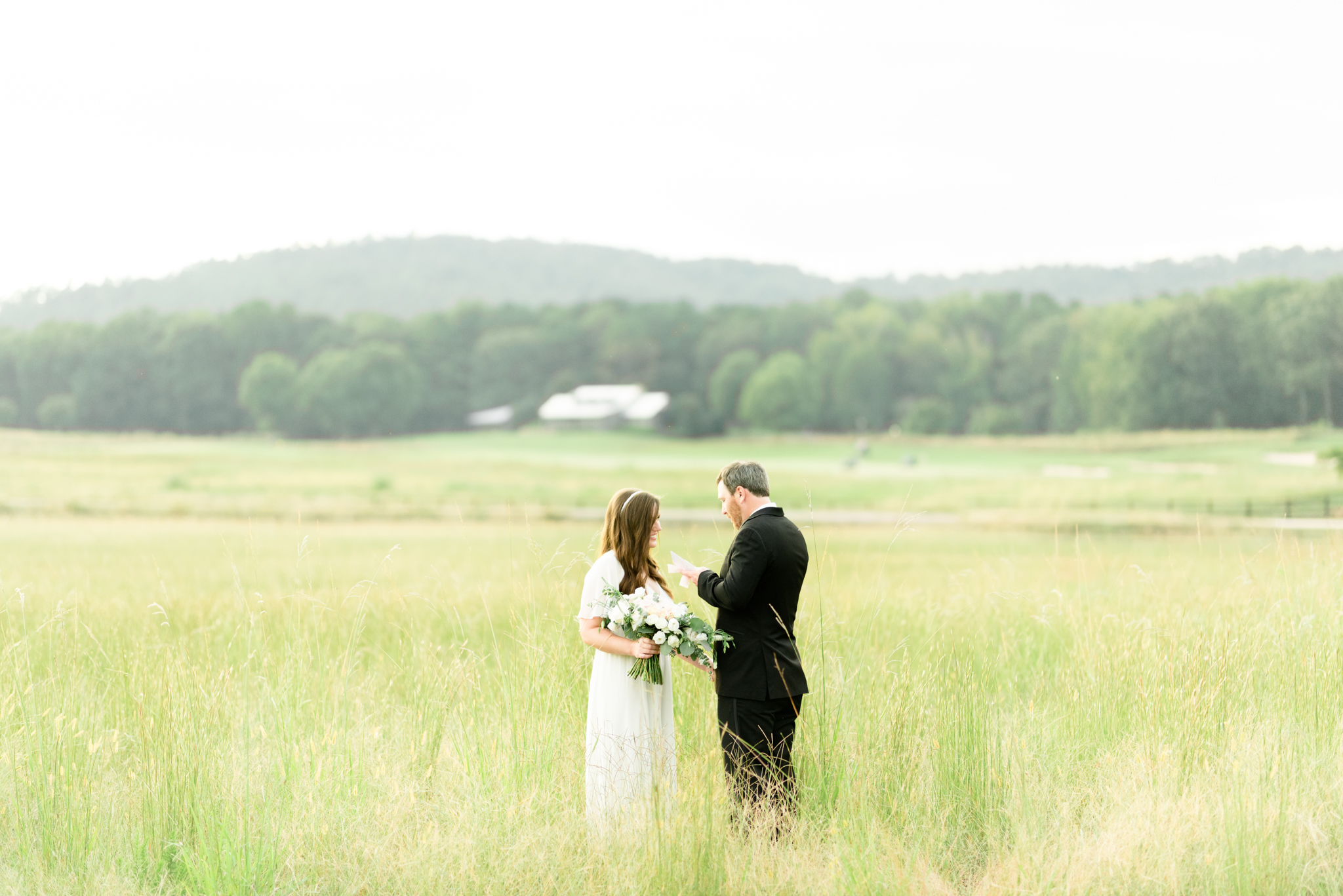 Couple stands in field and renews vows.