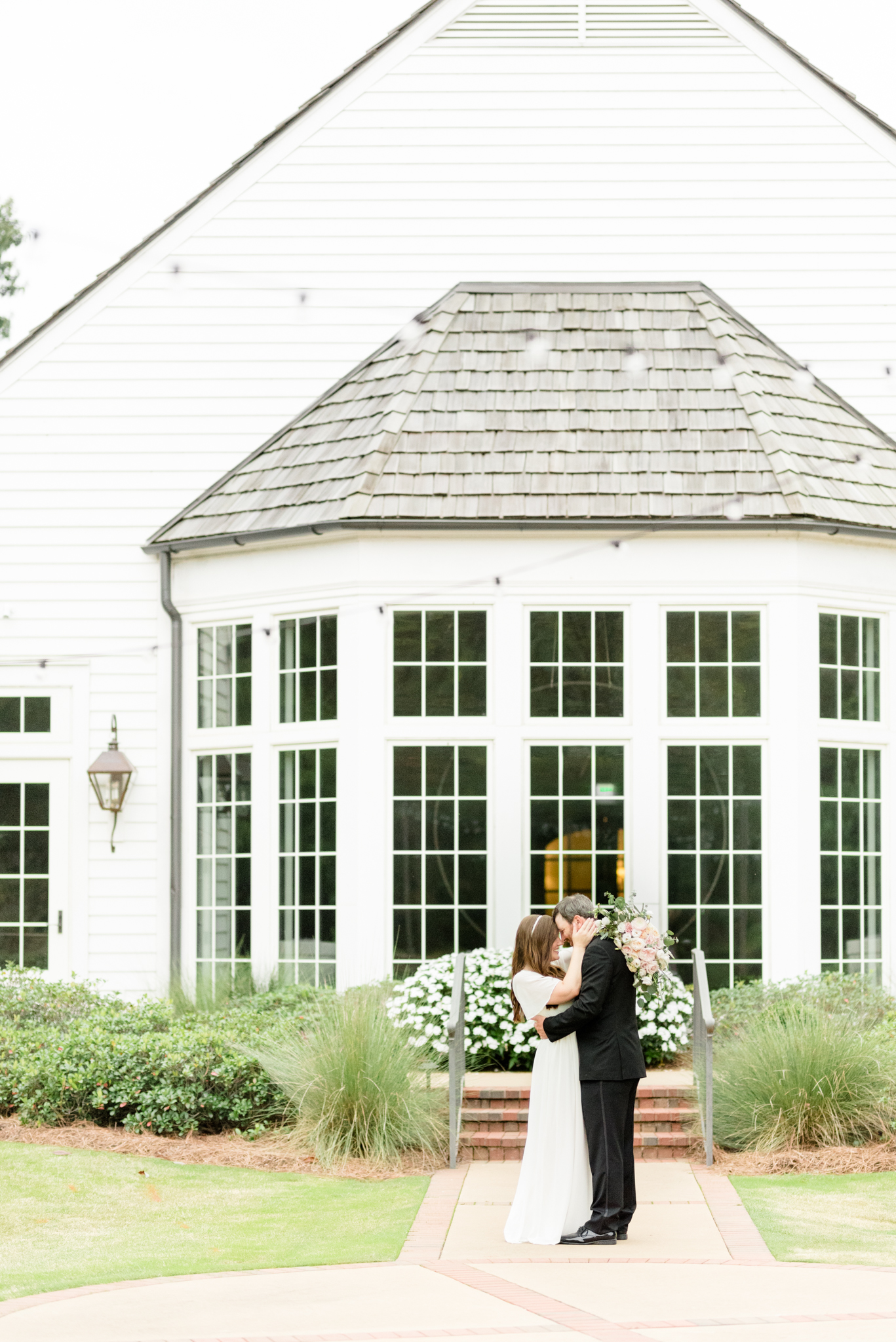 Bride and groom put foreheads together at Hamilton Place.