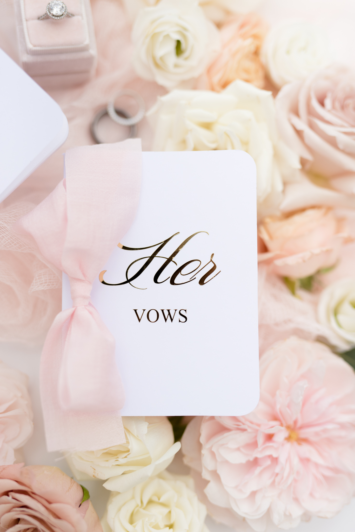 Bride's vow book sits on flowers.