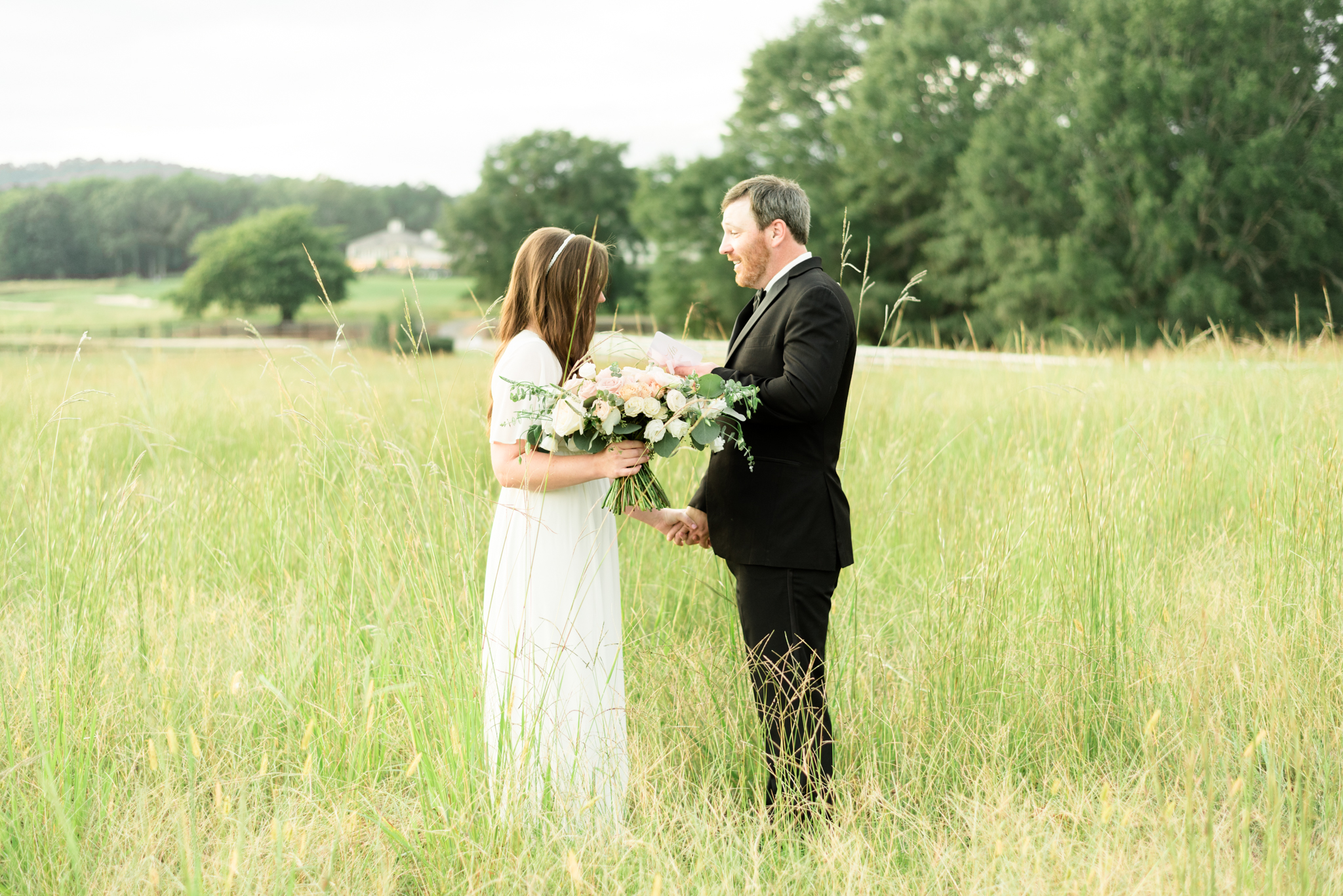 Husband and wife renew vows in field.