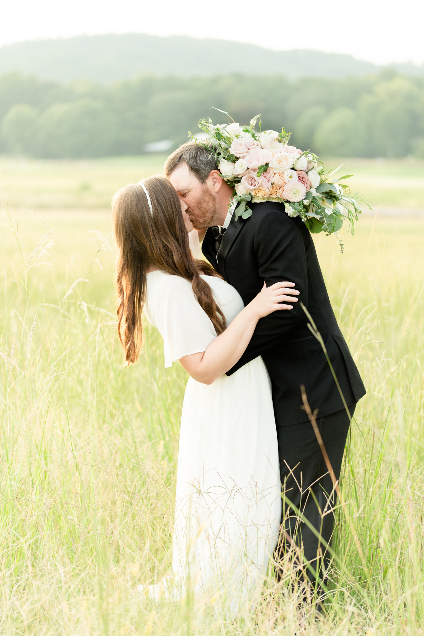 Groom dips bride back Pursell Farms field.