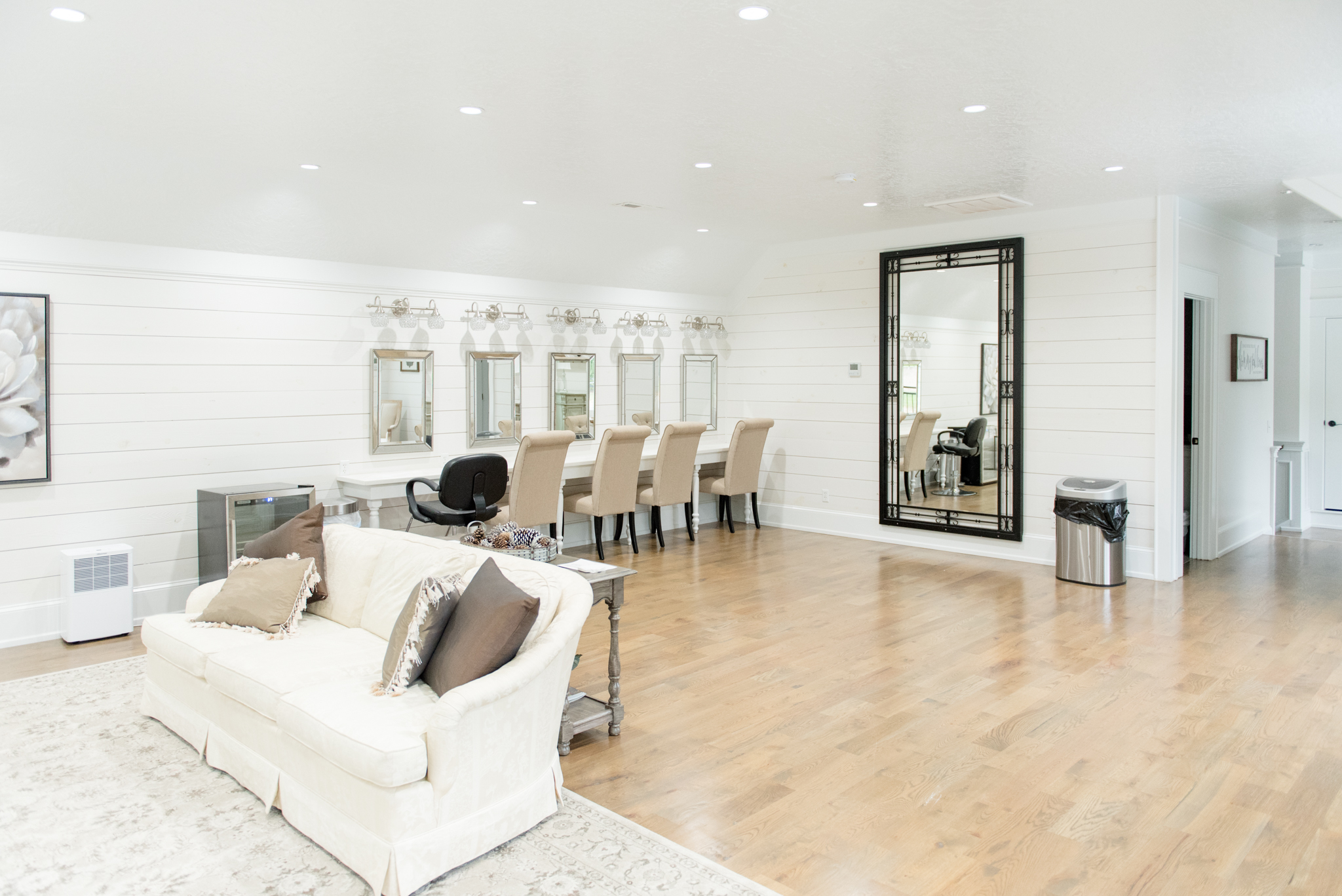 Couches and makeup mirrors in bridal suite.