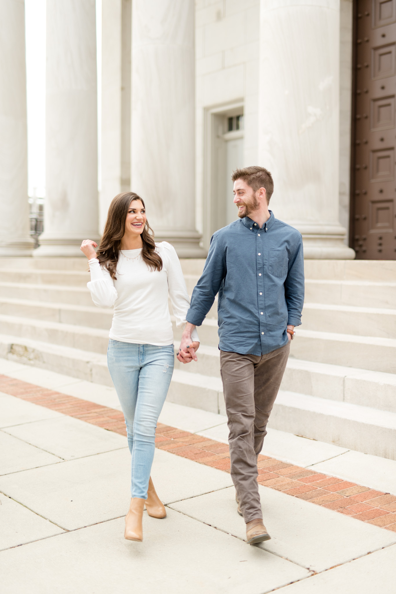 Couple walks and laughs together.