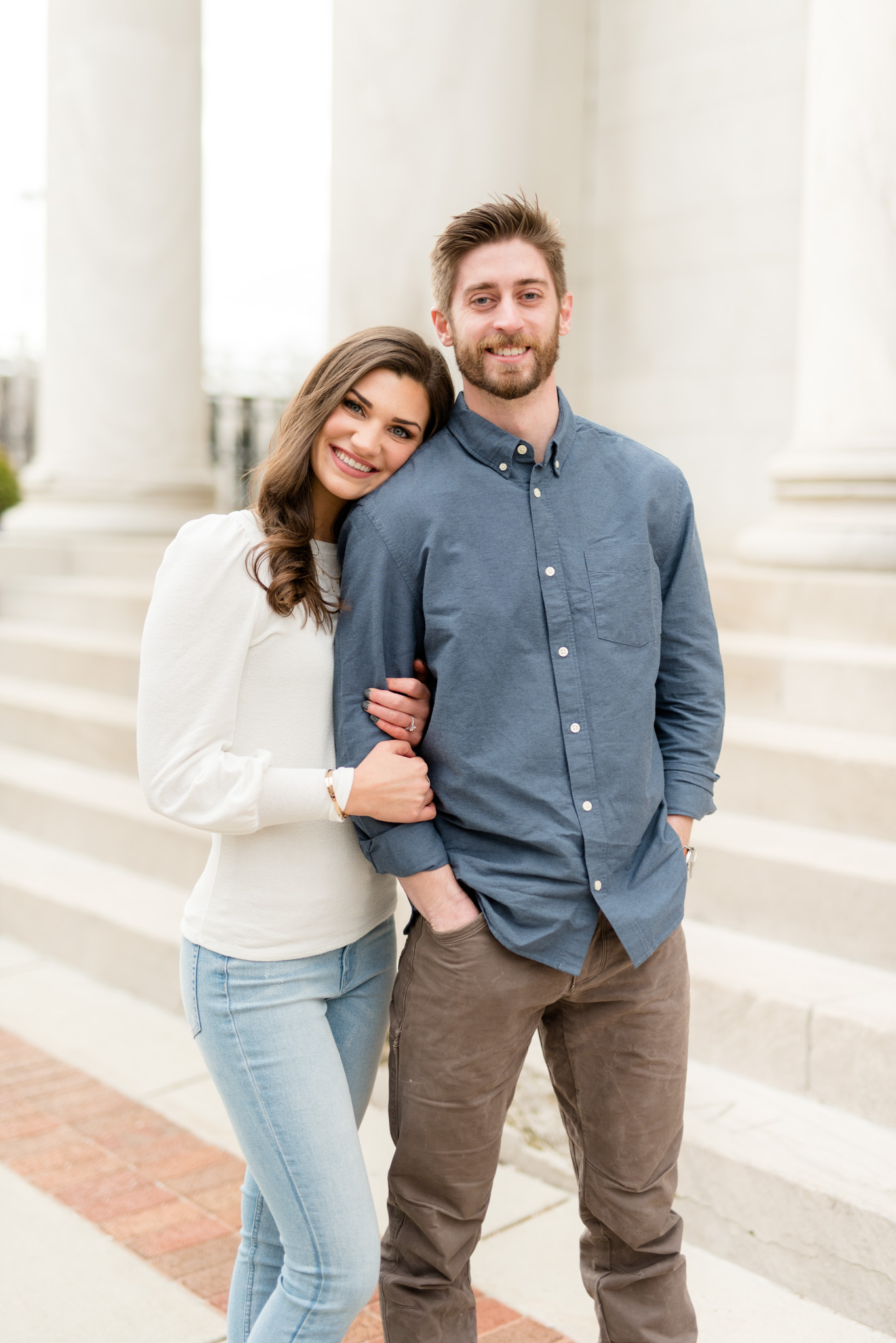 Woman leans her head on fiancÃ©'s shoulder.