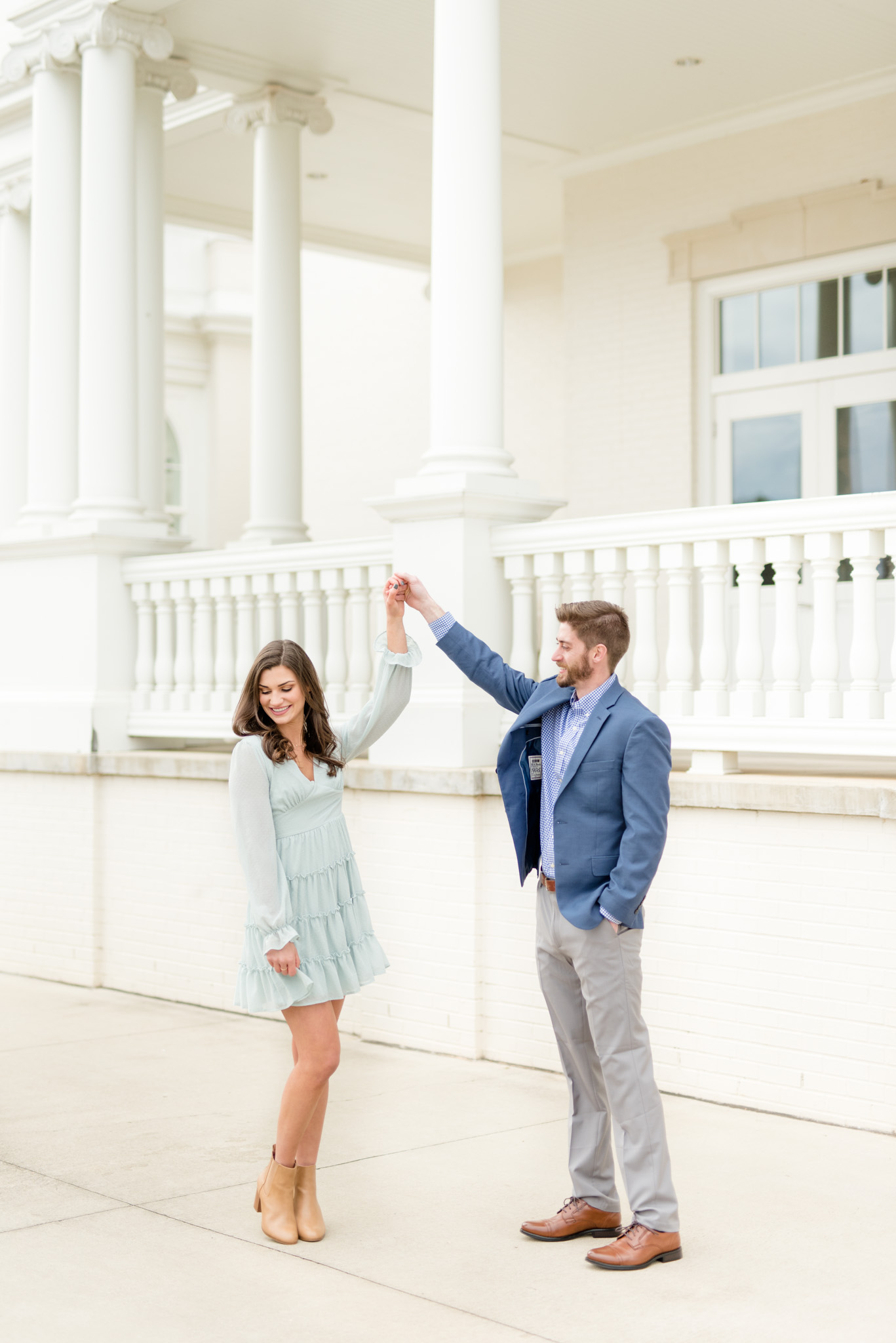 Man twirls fiancé at Huntsville Botanical Gardens.