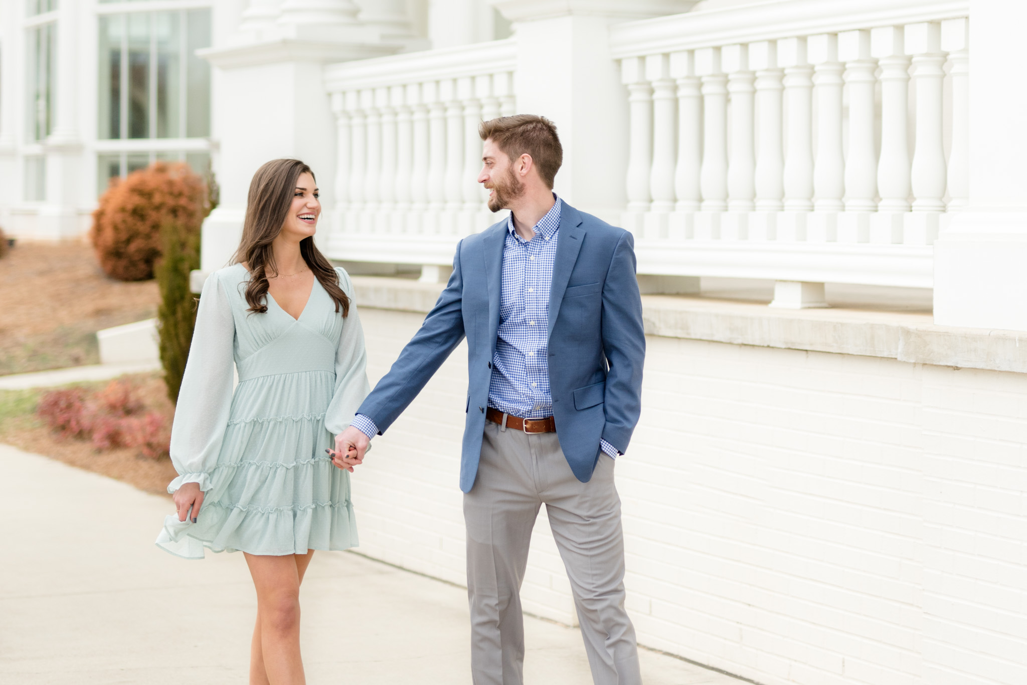 Couple laughs as they walk through Huntsville Botanical Gardens.