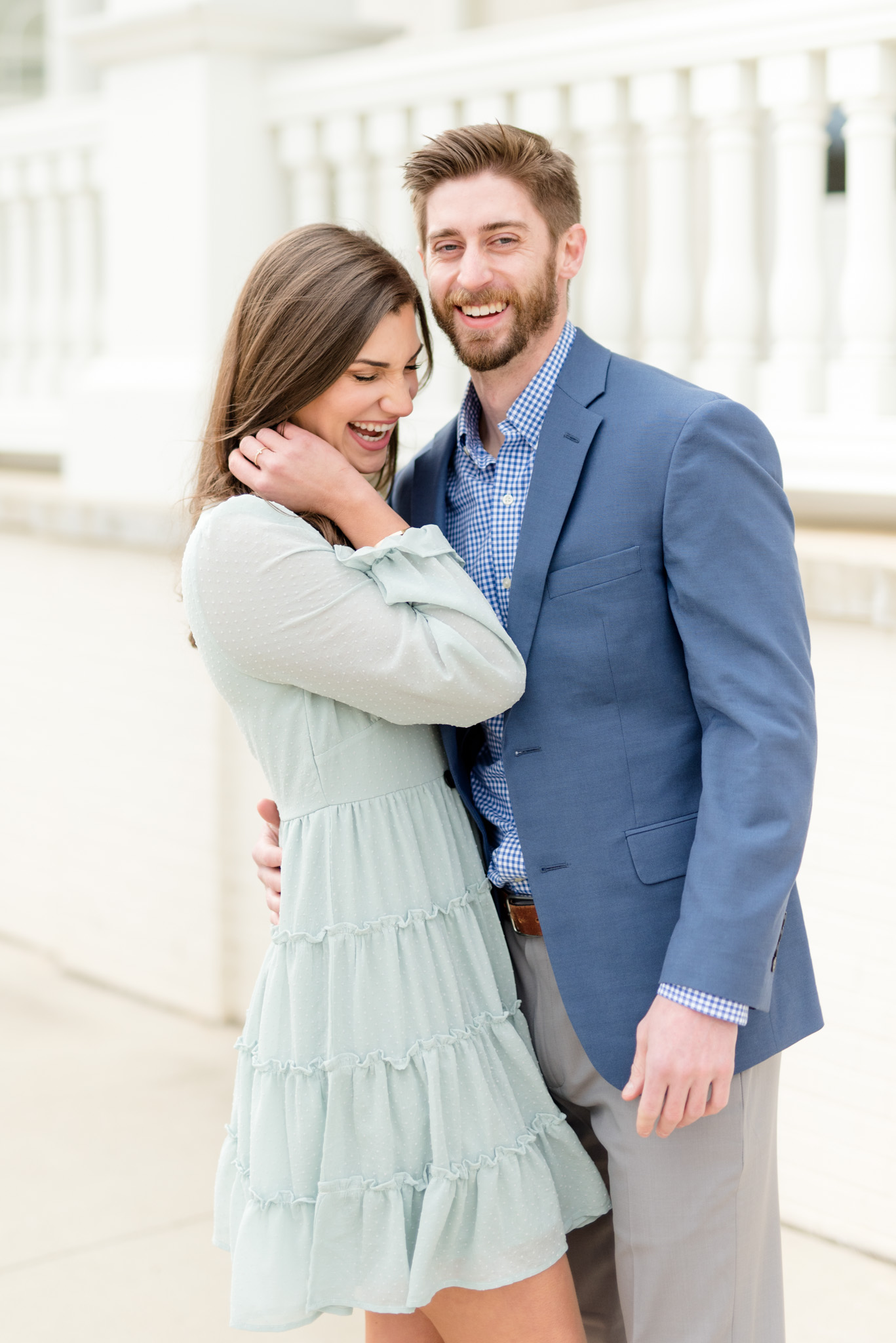 Engaged couple laugh at Huntsville Botanical Gardens.