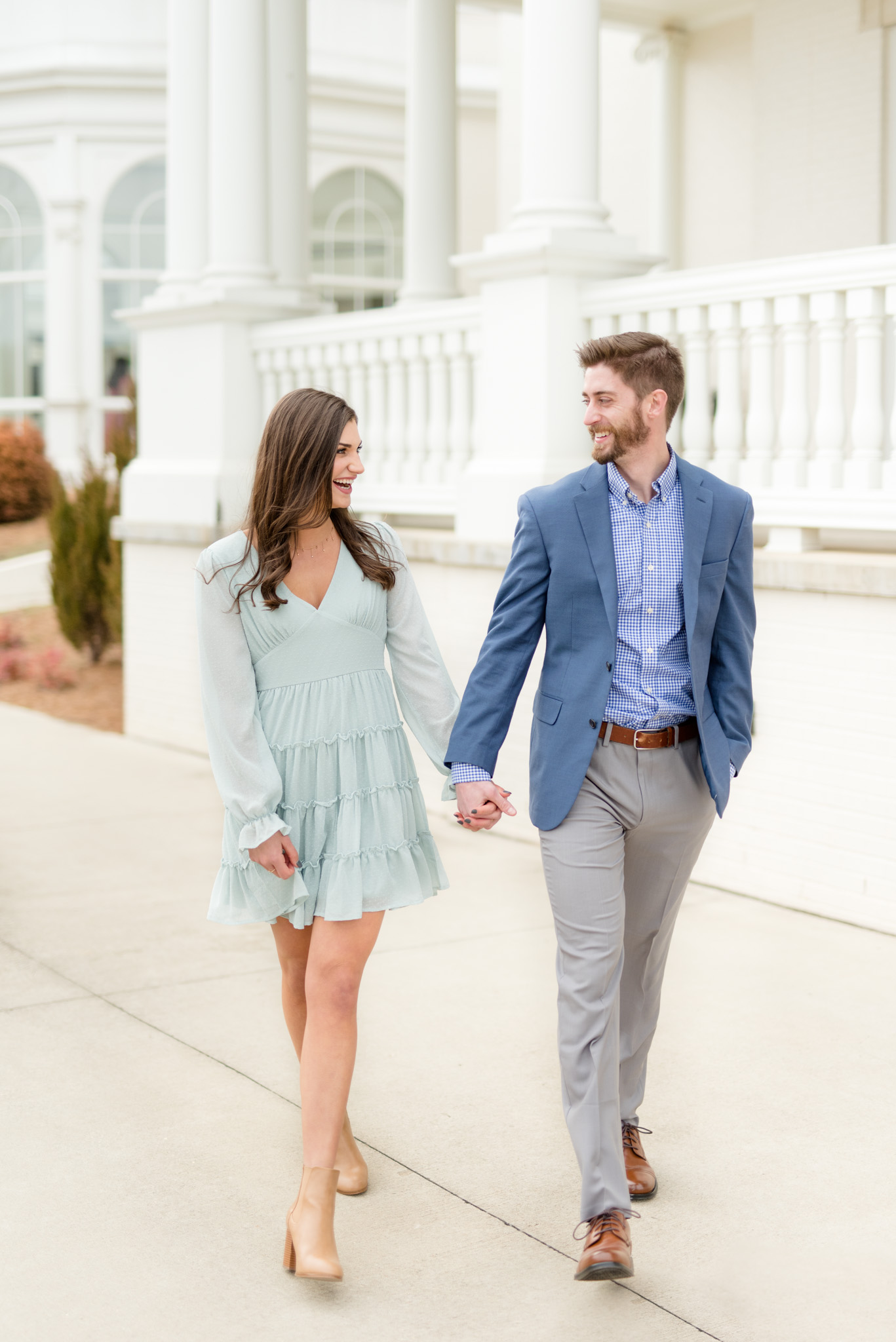 Couple laughs and walks through Huntsville Botanical Gardens.