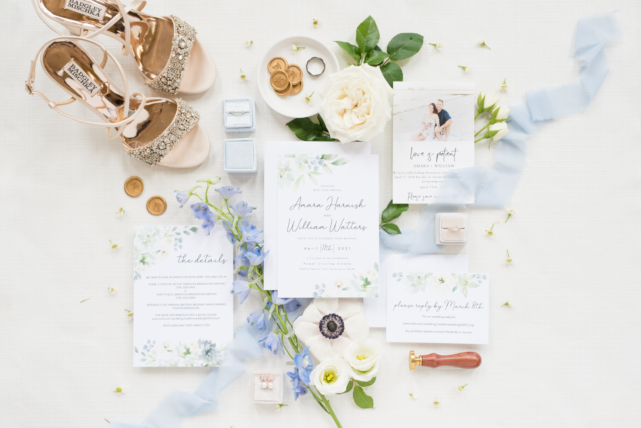 Wedding invitations sit with bride's details.