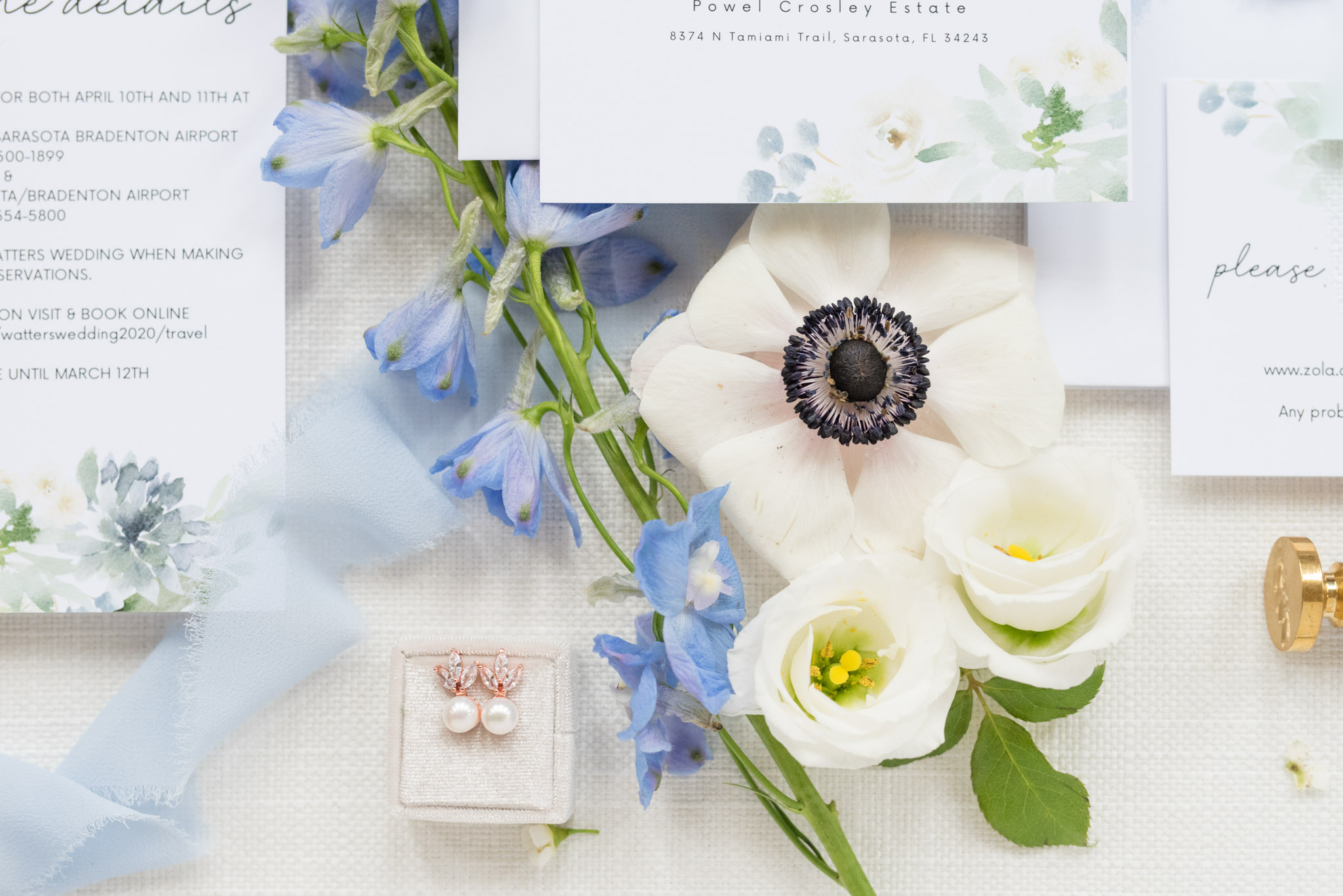 Blue and white flowers with invitations.