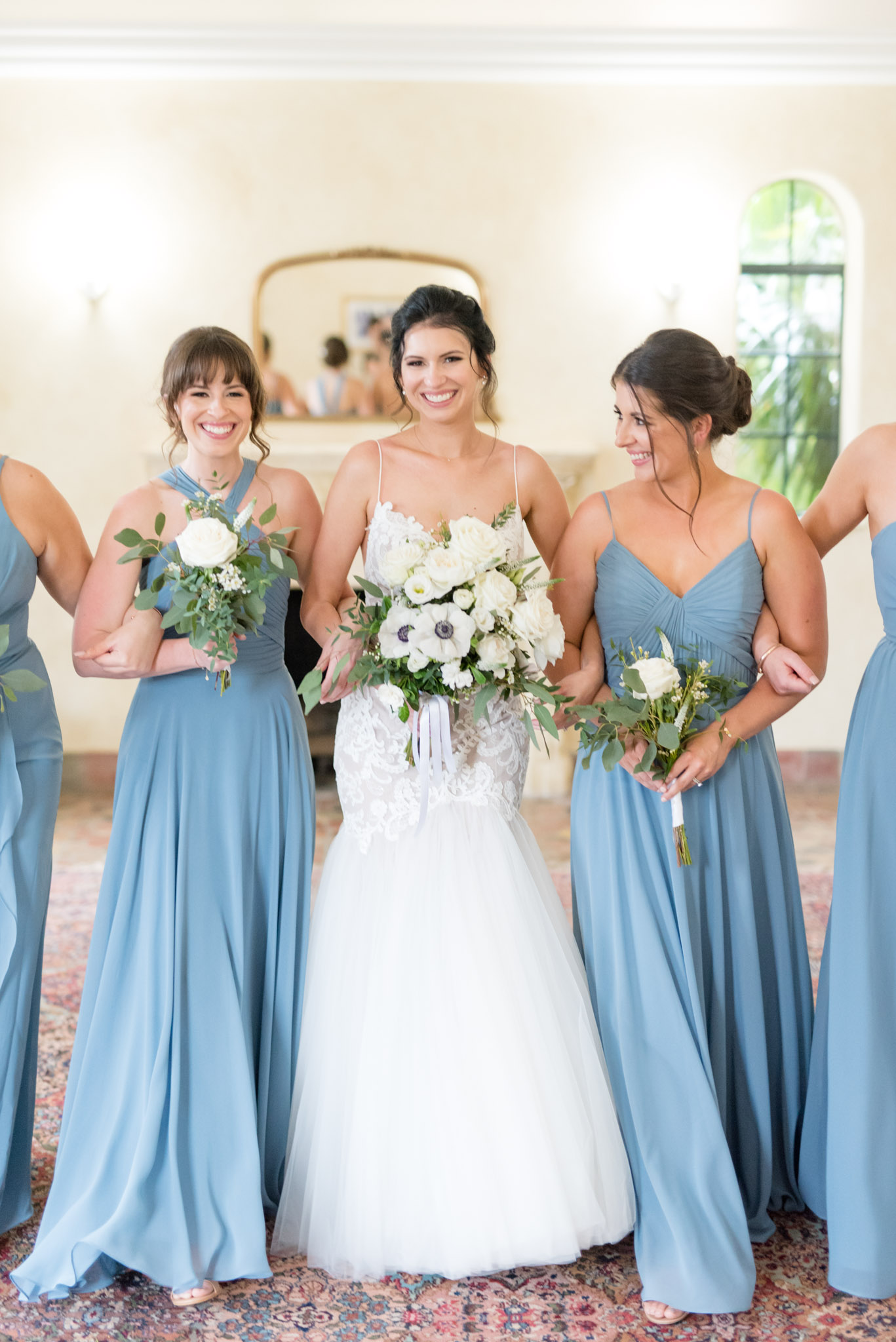 Bride walks with bridesmaids.