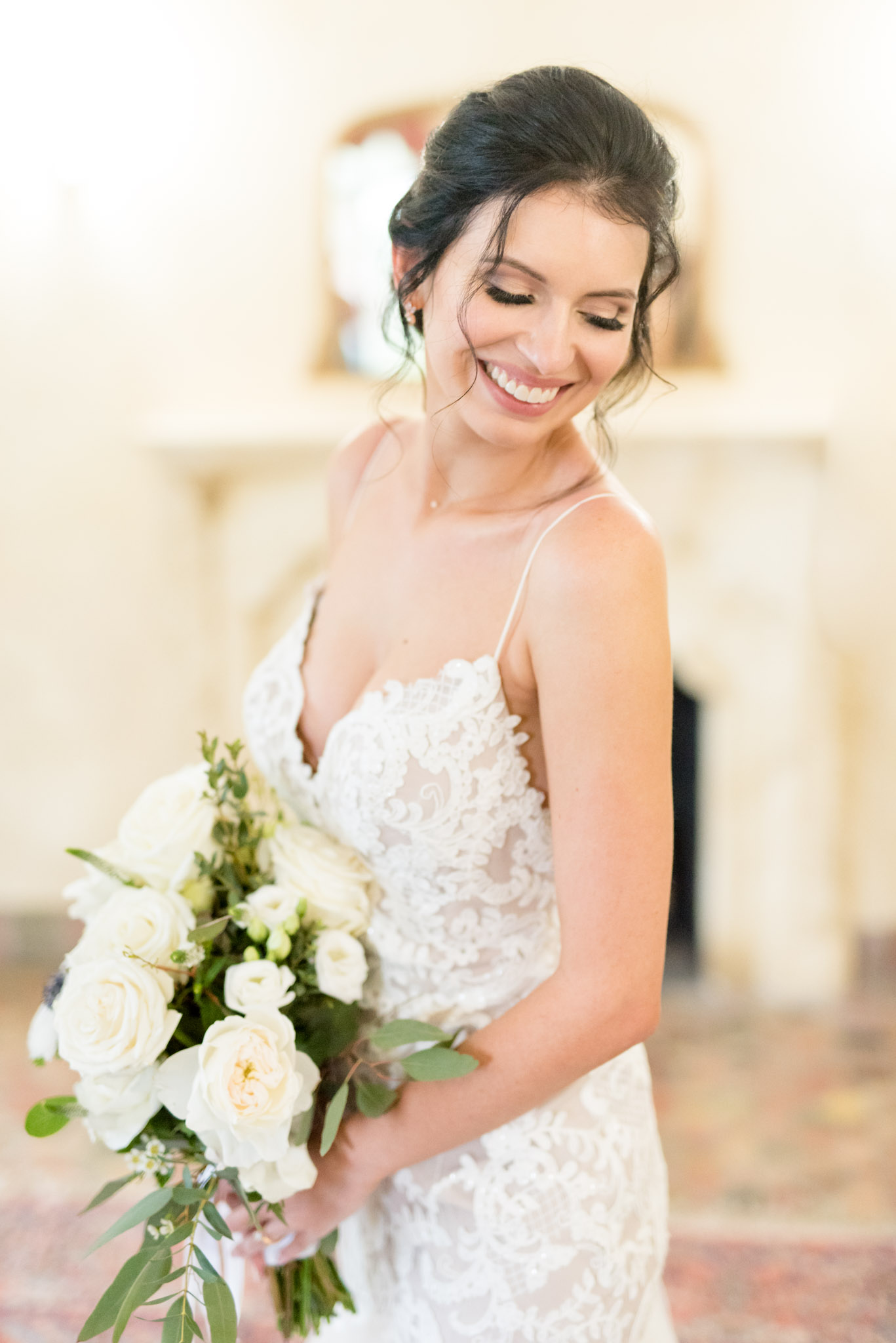 Bride smiles over shoulder.