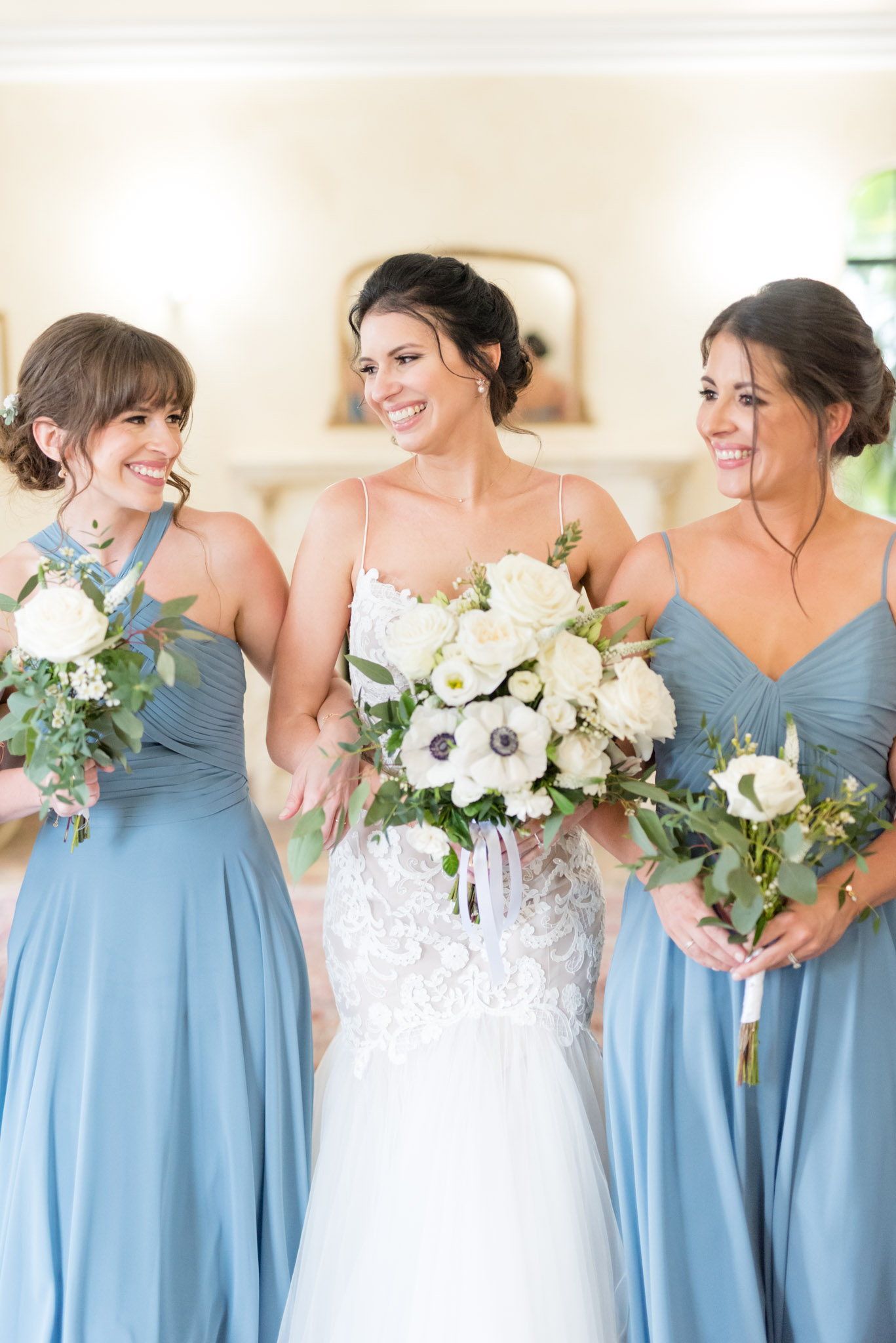 Bride smiles at sisters.