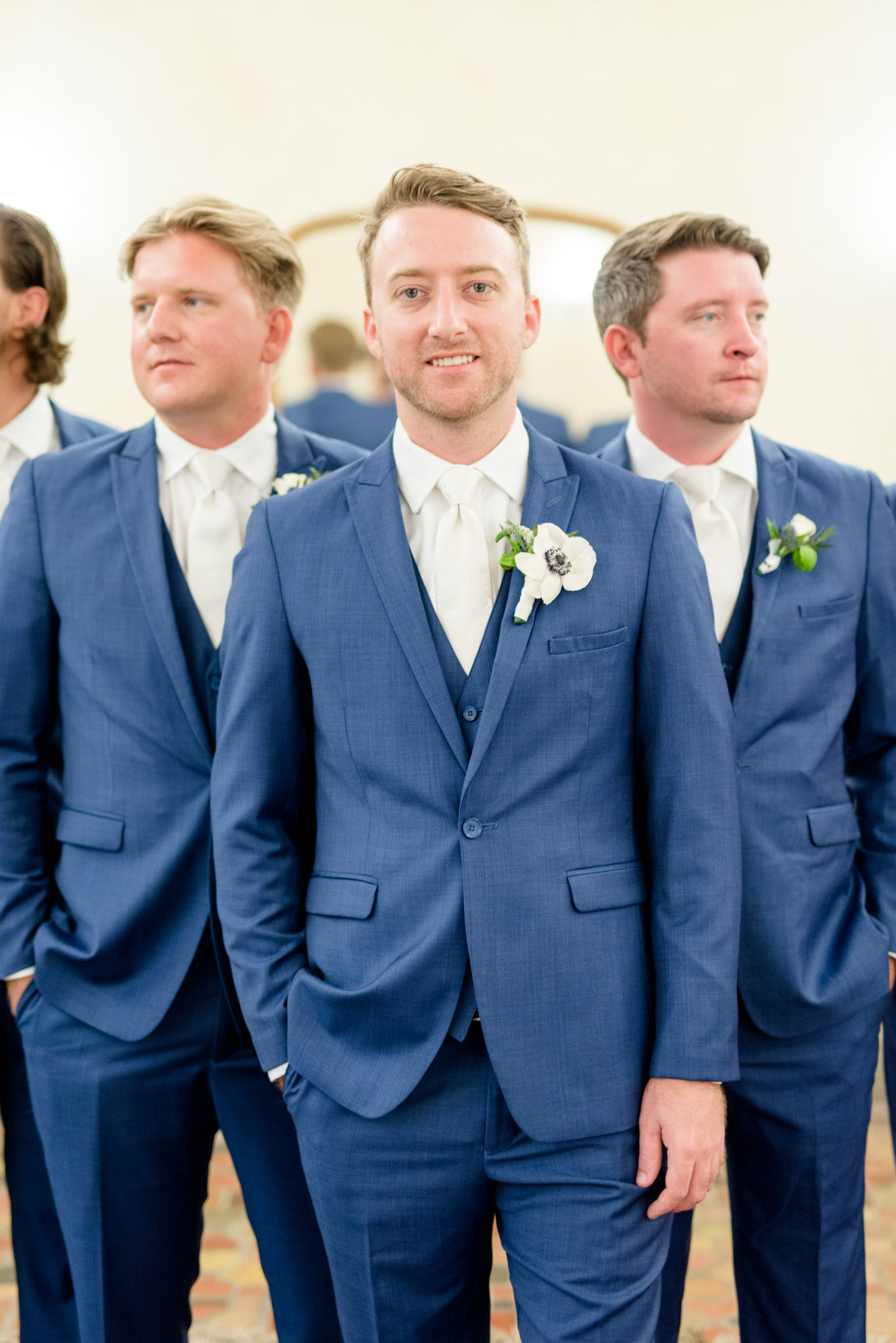 Groom smiles at camera.