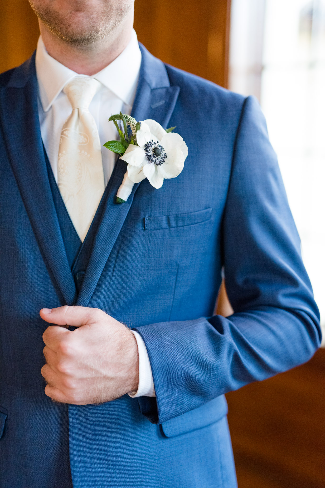 Groom's boutonniere on his jacket.