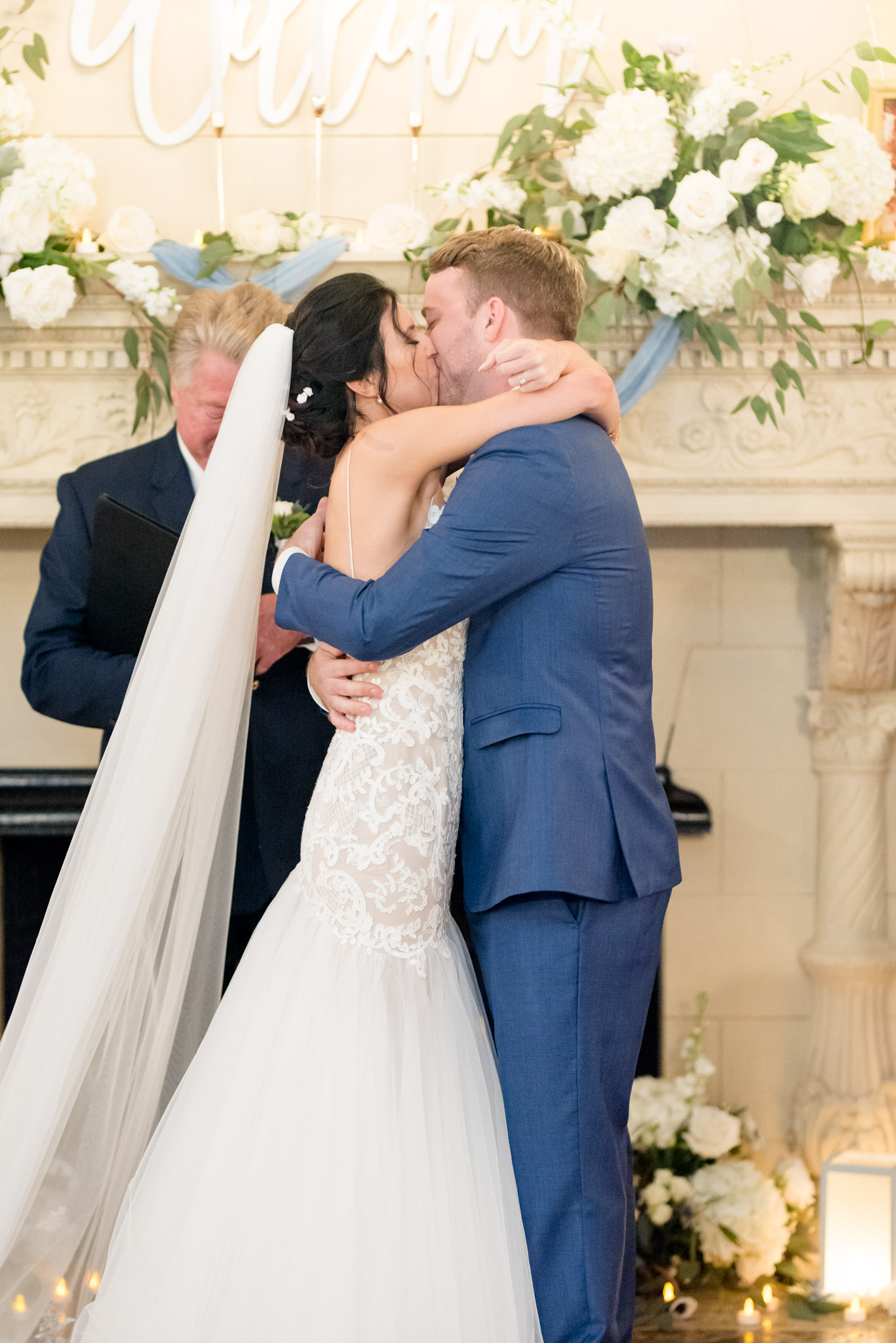 Bride and groom kiss at altar.