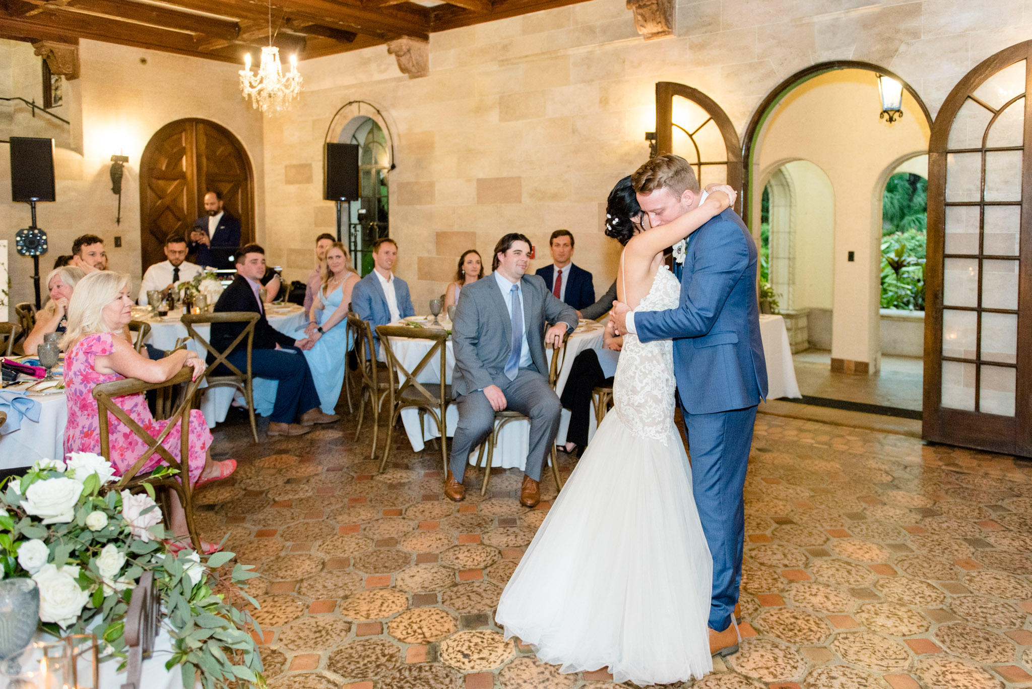 Bride and groom hold each other during first dance.