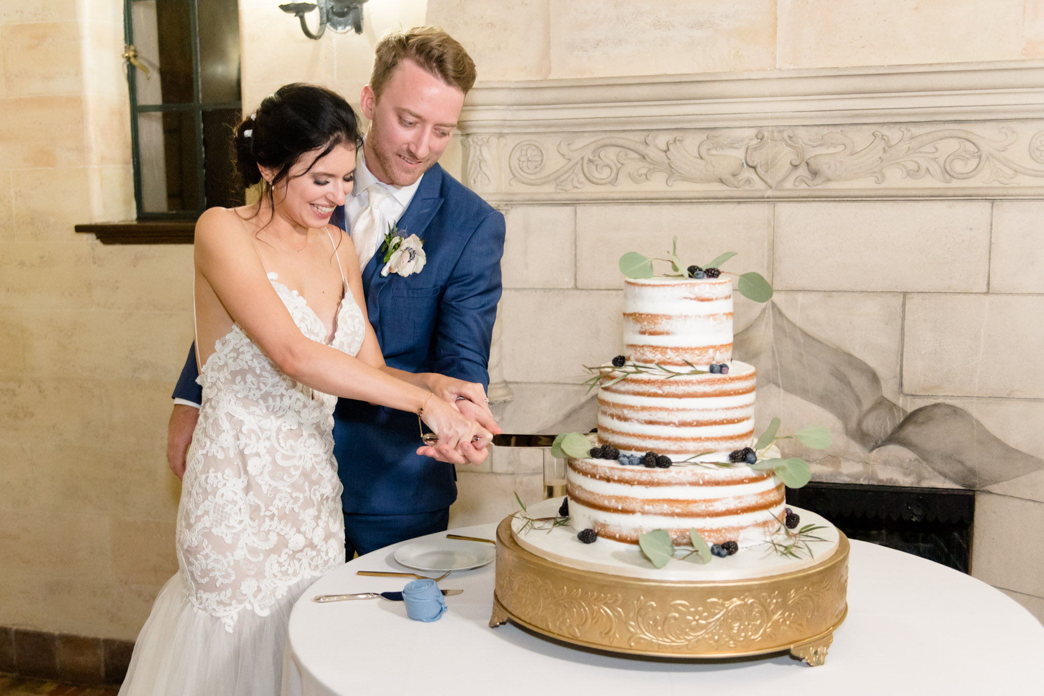 Couple cuts cake at wedding.