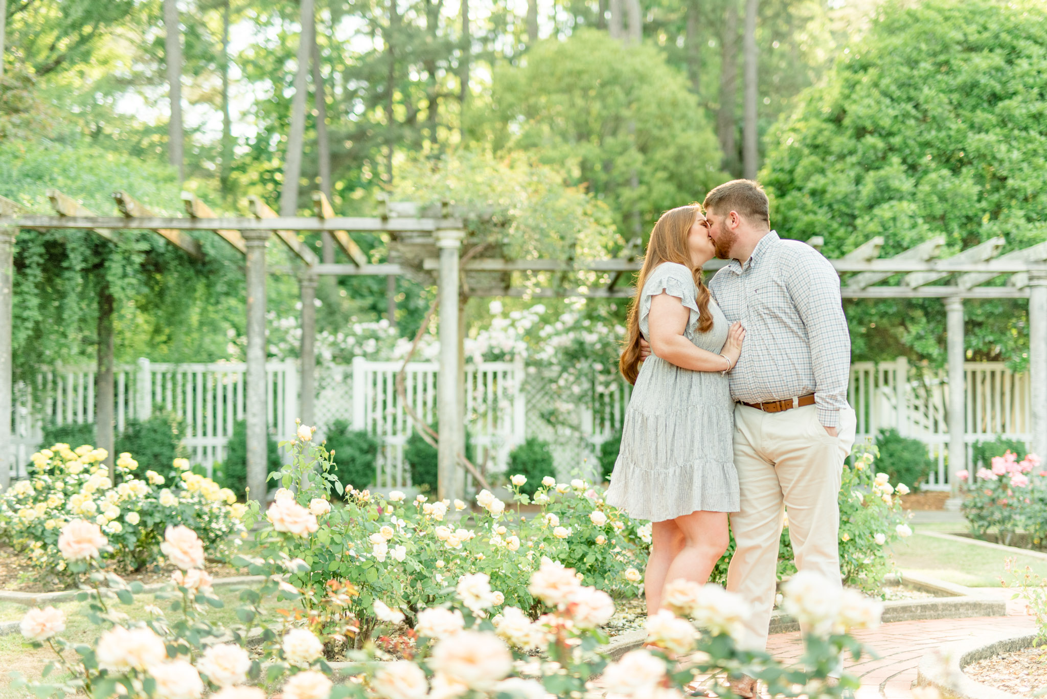 Couple kisses in Birmingham Botanical Gardens.