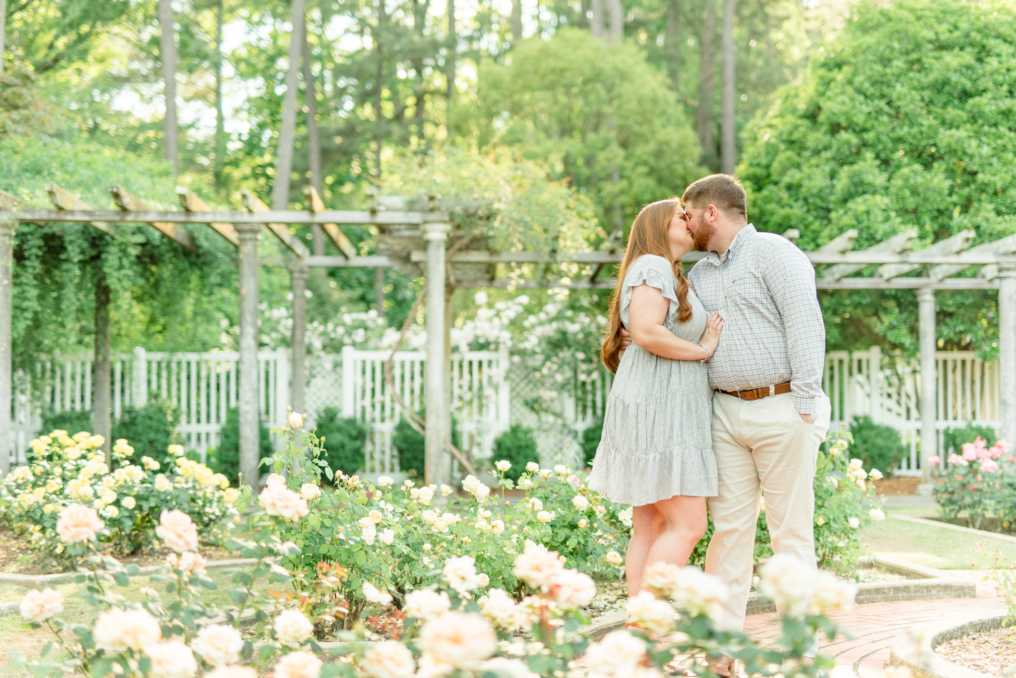 Couple kisses in Birmingham Botanical Gardens.