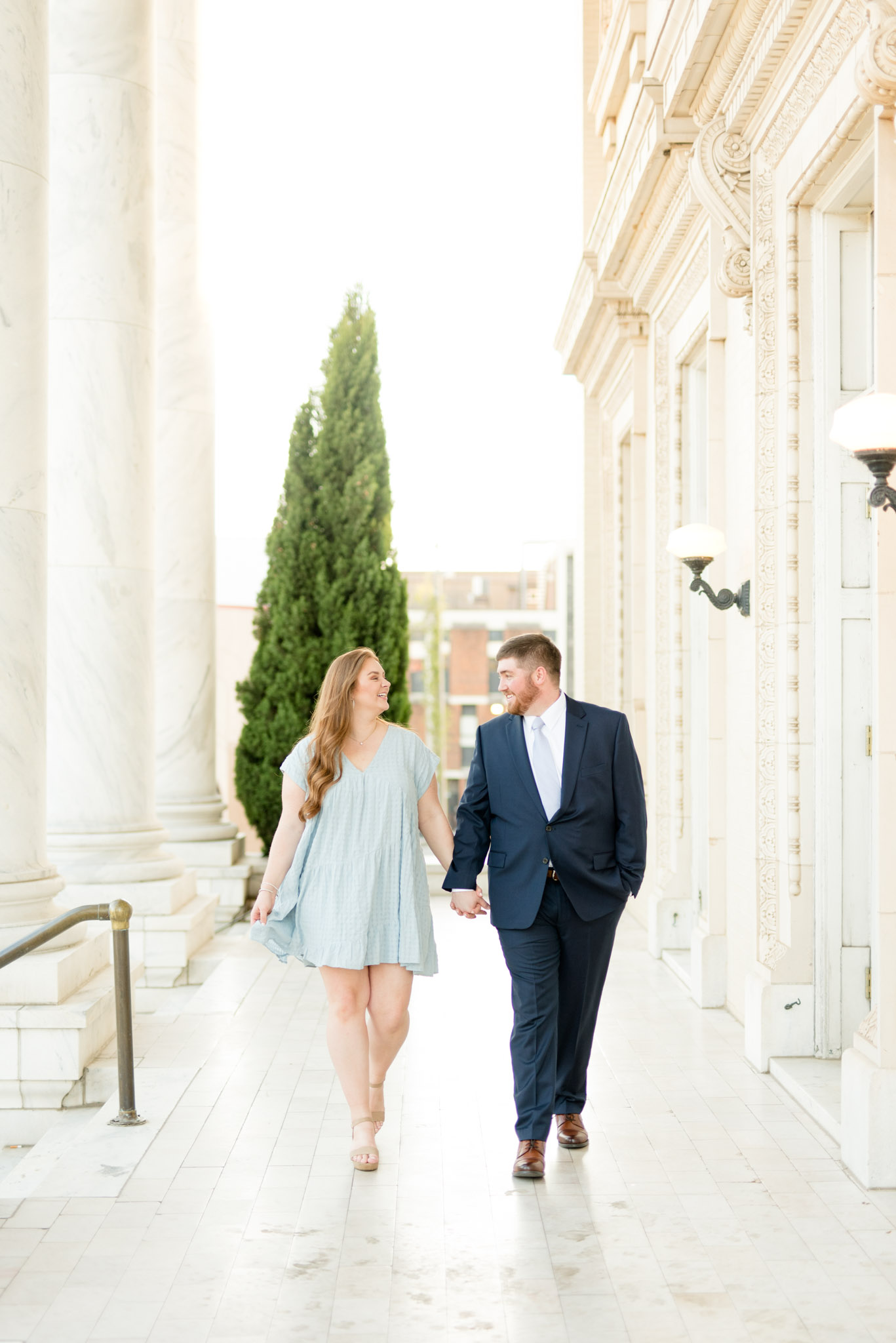 Couple smiles and walks together.