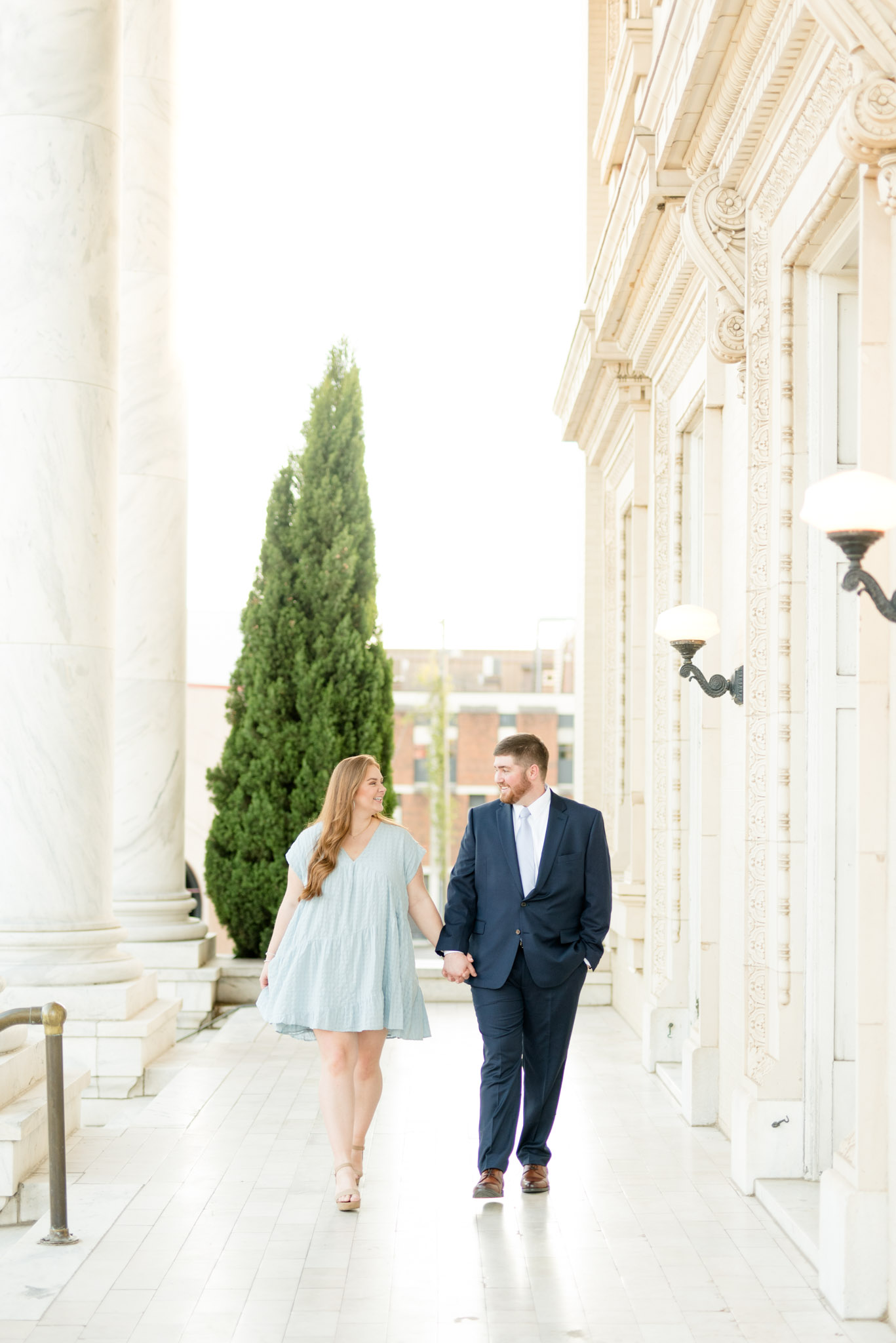 Couple walks down pathway together.