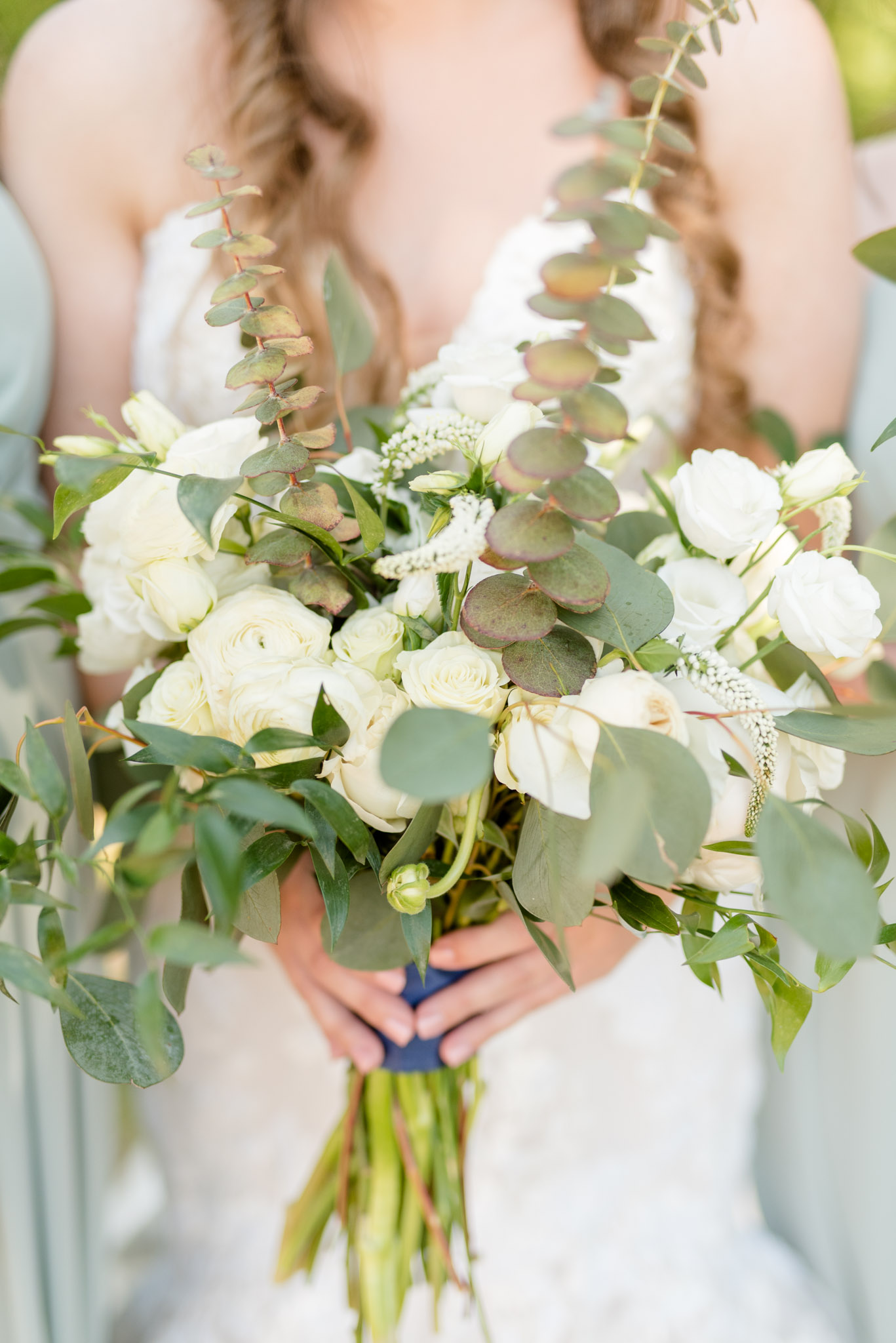 Bride holds flowers.